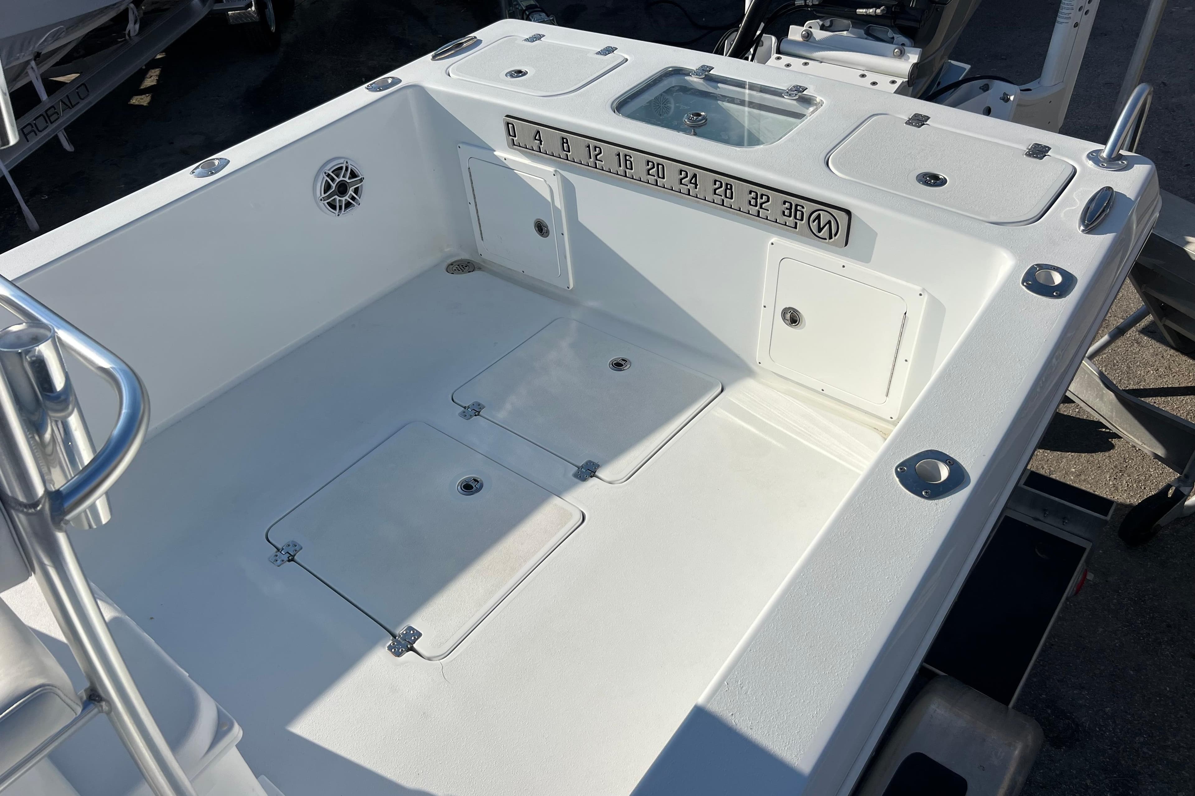 2024 Andros Tarpon 26 boat deck with storage compartments and measurement scale.