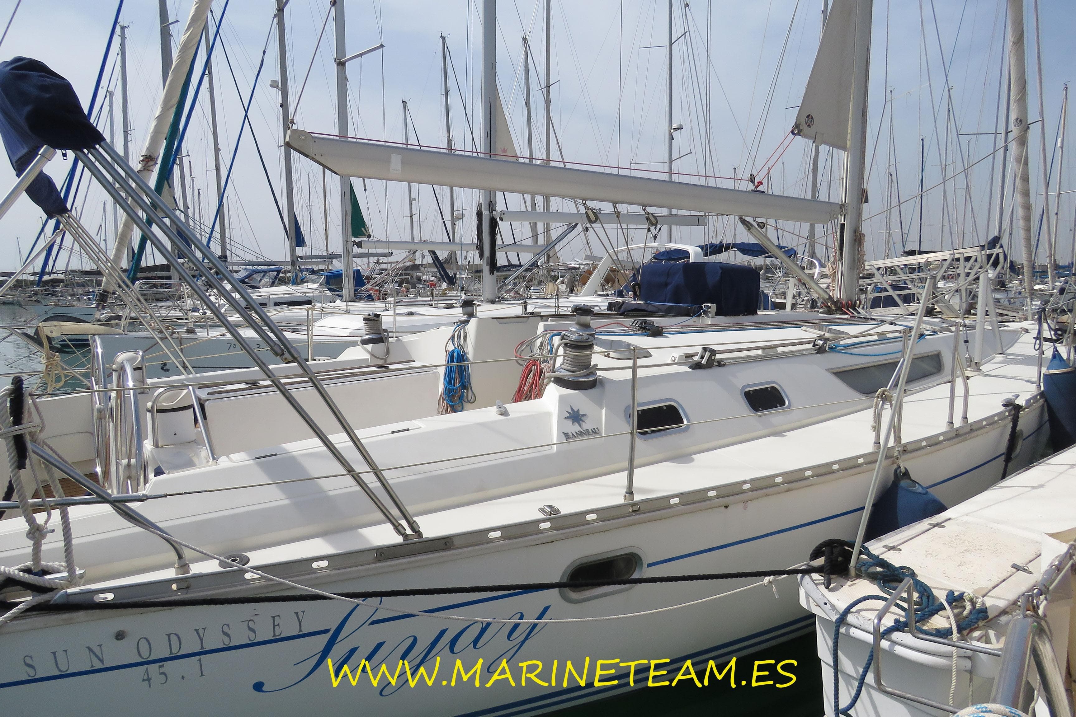 1995 Jeanneau Sun Odyssey 45.1 sailboat docked in a marina, showcasing sleek design and rigging.