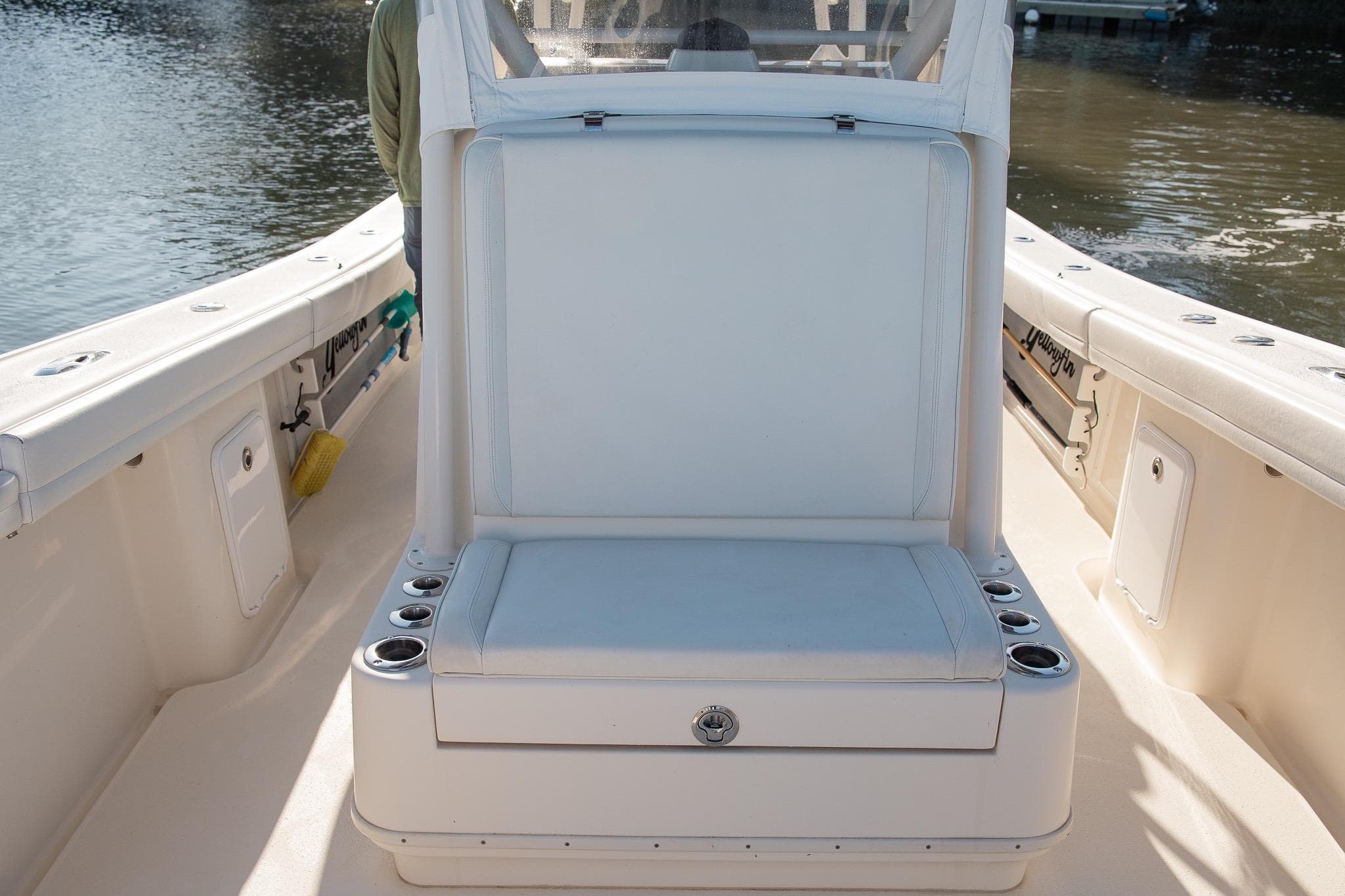 2014 Yellowfin 34 Offshore boat interior with cushioned seating and cup holders.
