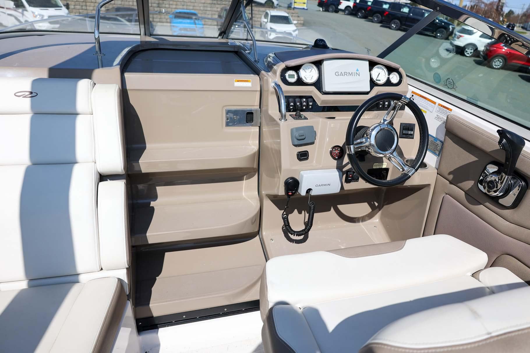 2017 Regal 28 Express boat cockpit with steering wheel and Garmin navigation system.