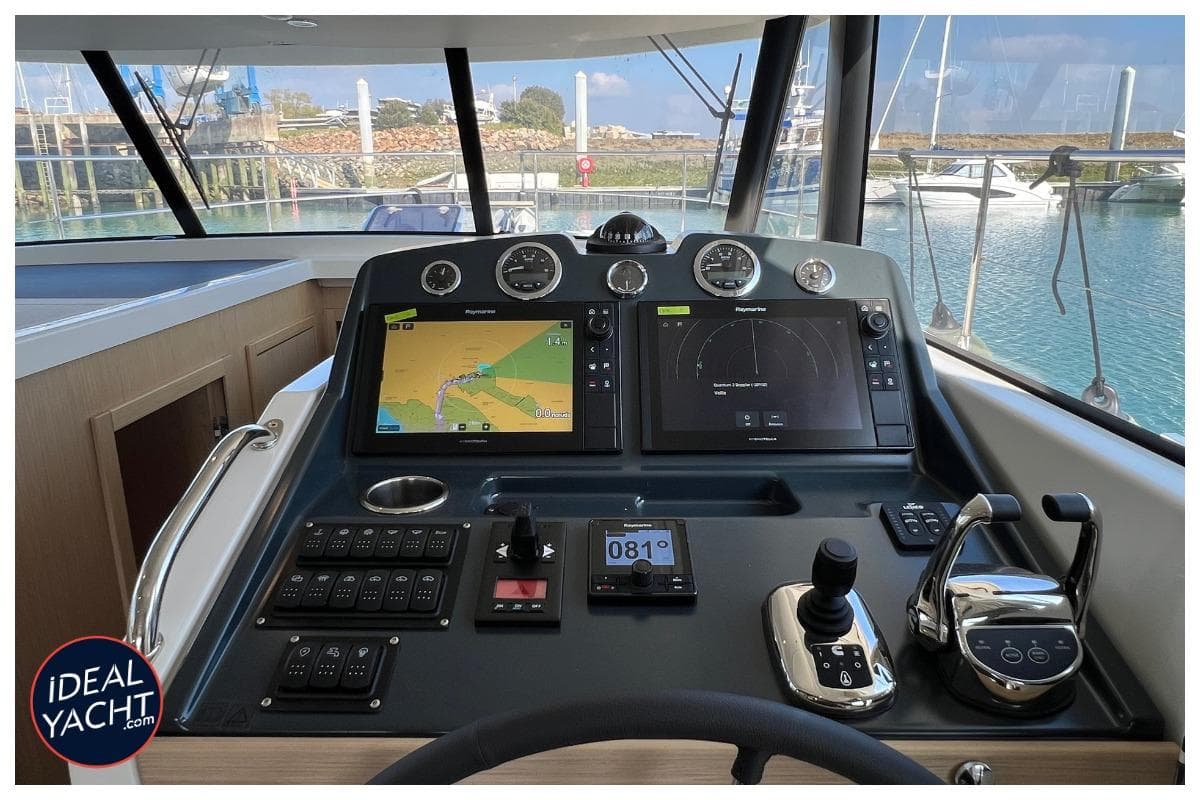 Helm of 2023 Beneteau Swift Trawler 48 with navigation screens and controls.
