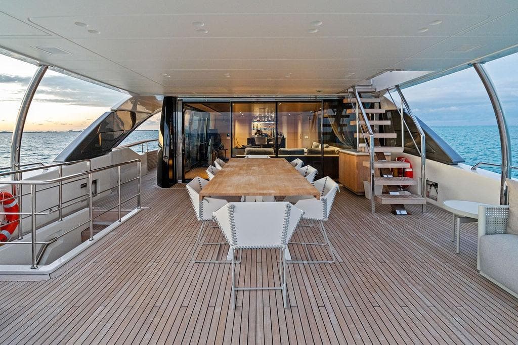 Luxurious 2023 Sanlorenzo SD118 yacht deck with elegant dining area and ocean view.