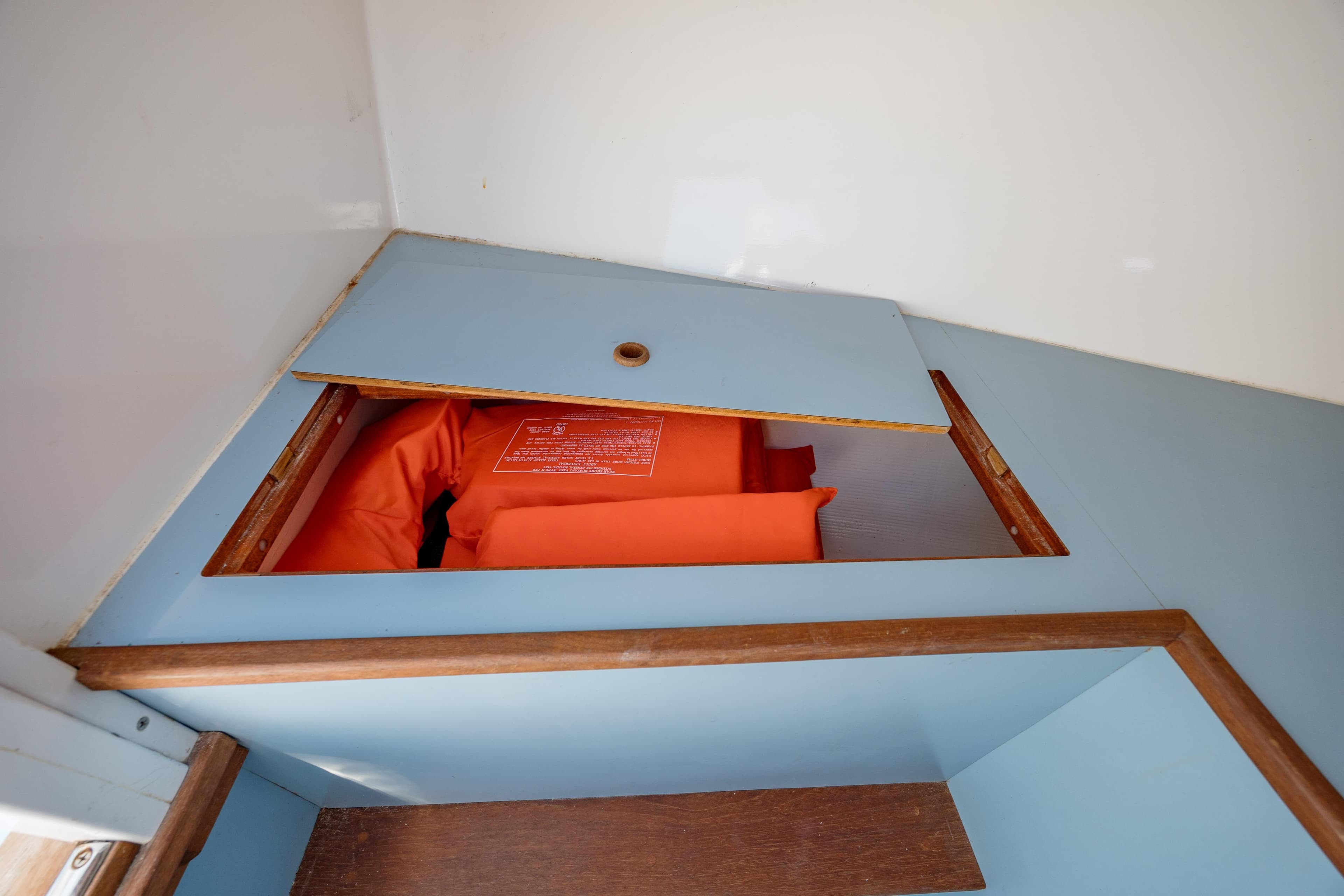 2019 Gamefisherman 26 Cuddy Cabin storage with orange life jackets.