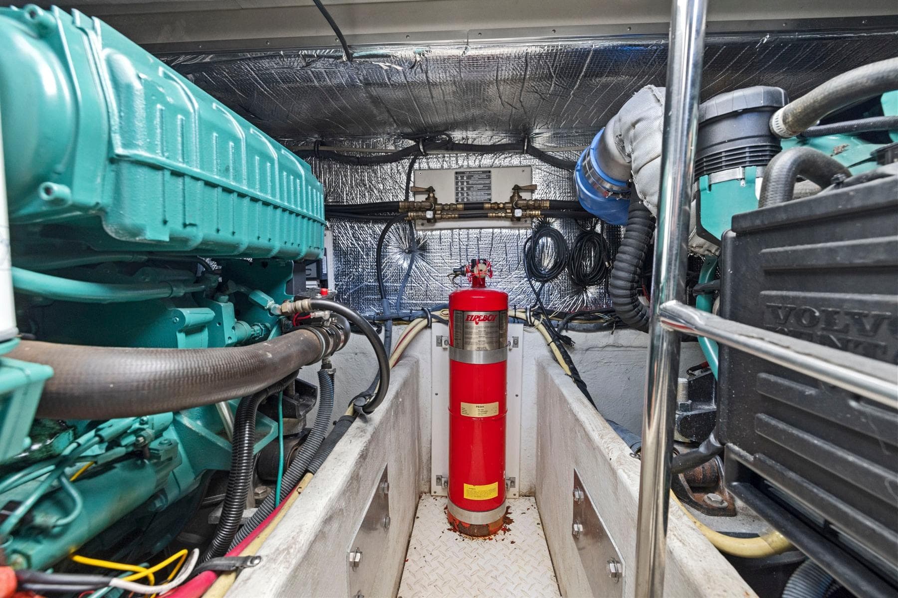 Engine room of 2008 Cruisers Yachts 447 Sport Sedan with fire extinguisher and machinery.