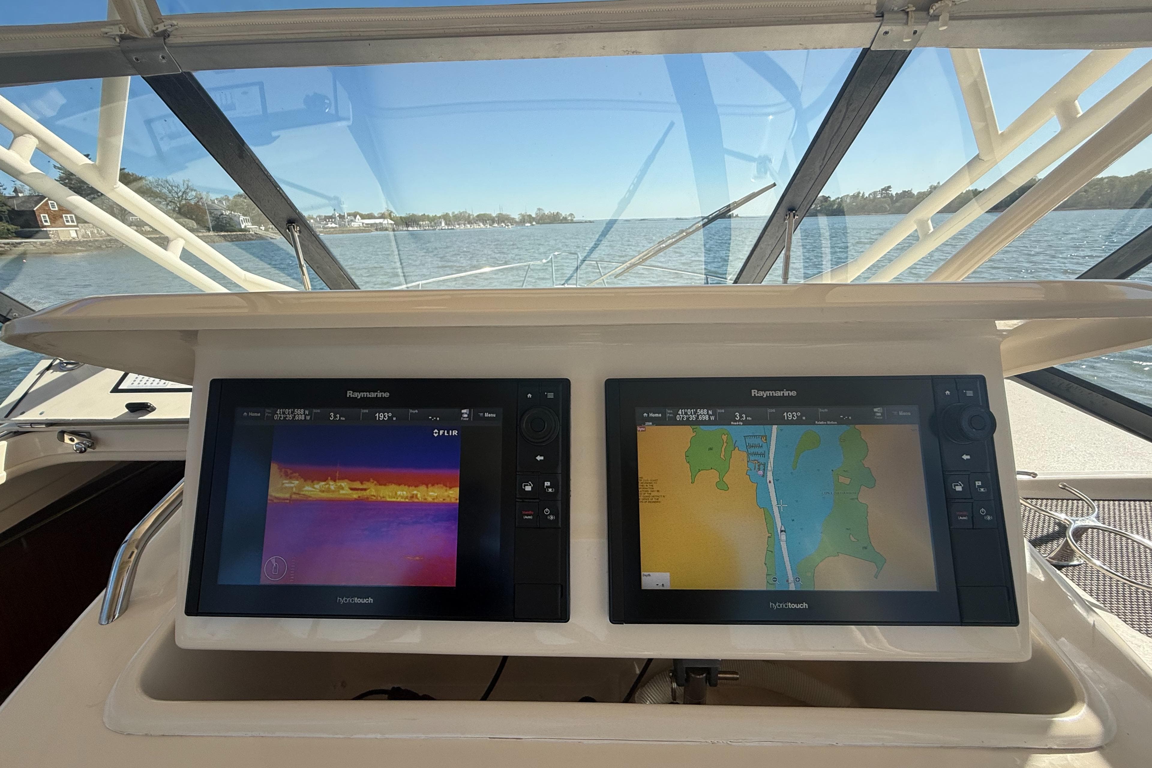 2016 Grady-White Express 330 helm with dual navigation screens, overlooking calm waters.