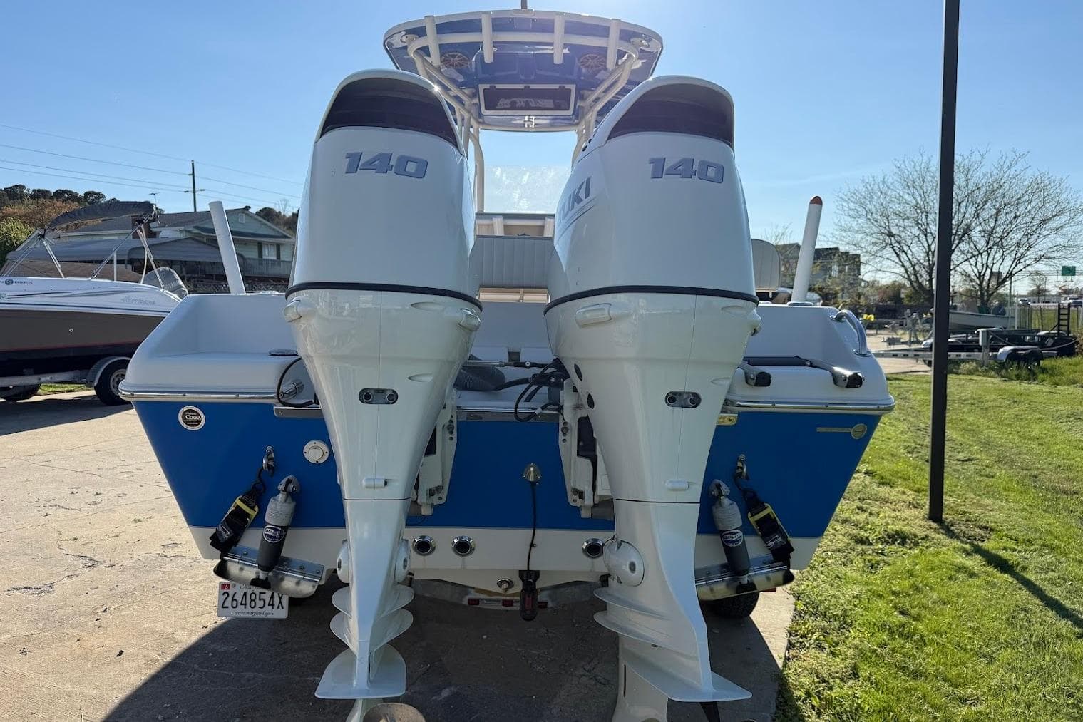 2019 Sea Chaser 24 HFC boat with dual 140 horsepower outboard engines, parked outdoors.