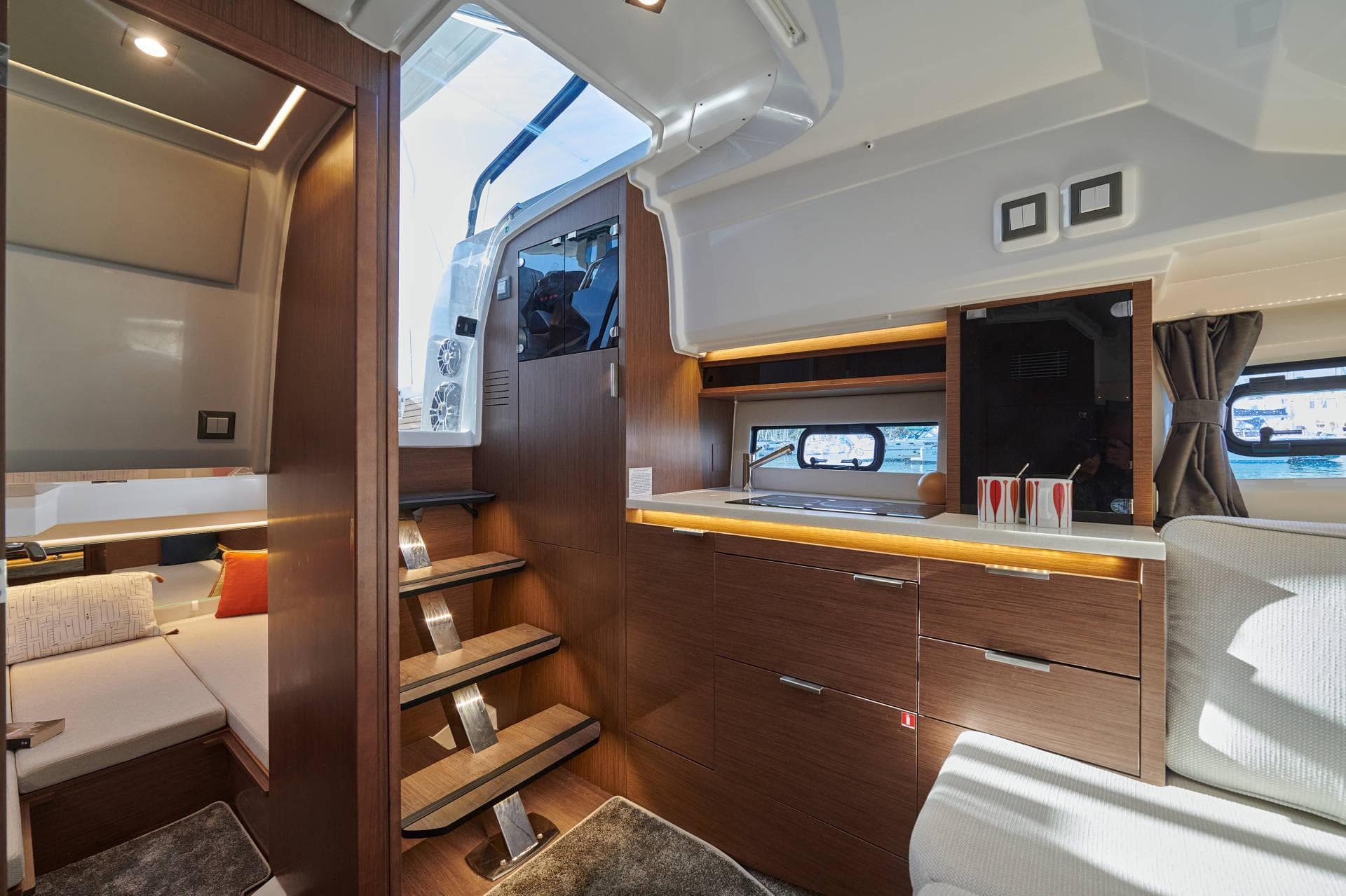 Interior of 2025 Jeanneau Leader 10.5 WA Series 2, featuring modern wood finishes and cozy seating.