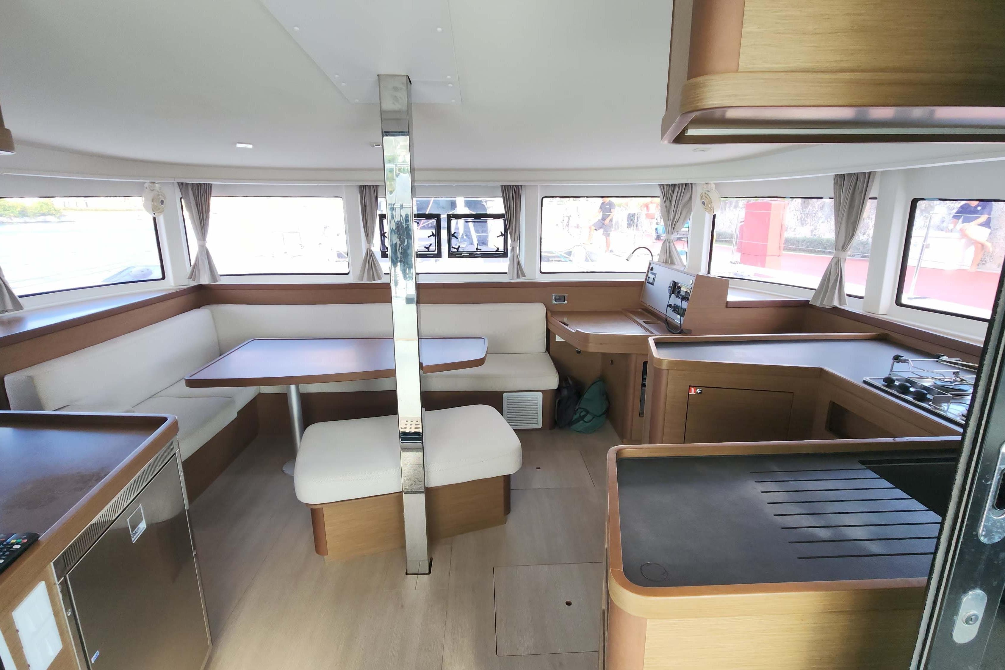 Interior of 2020 Lagoon 42 catamaran with modern kitchen and dining area.