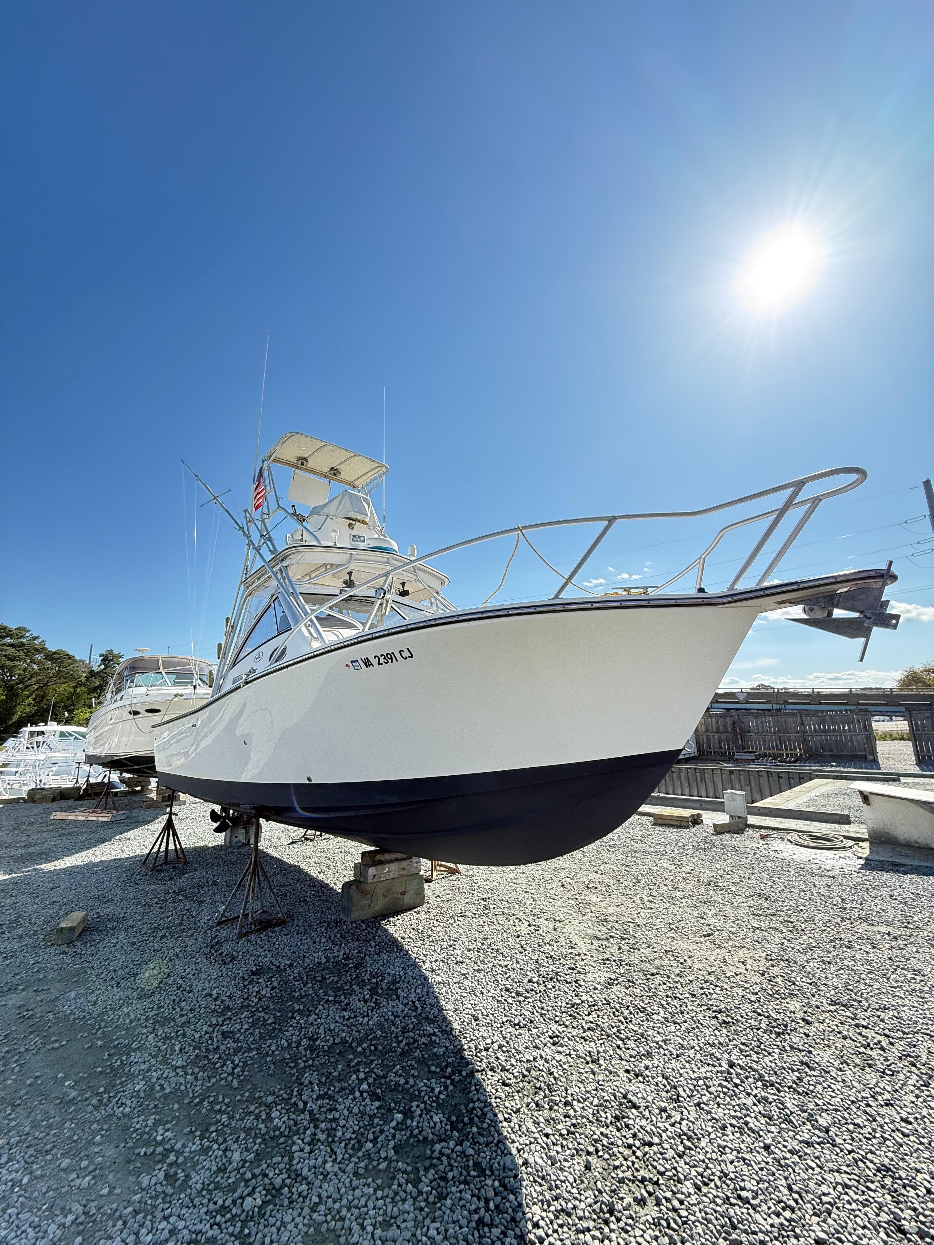 2001 Albemarle 280 Express Sport Fisherman boat on dry dock under clear sky.