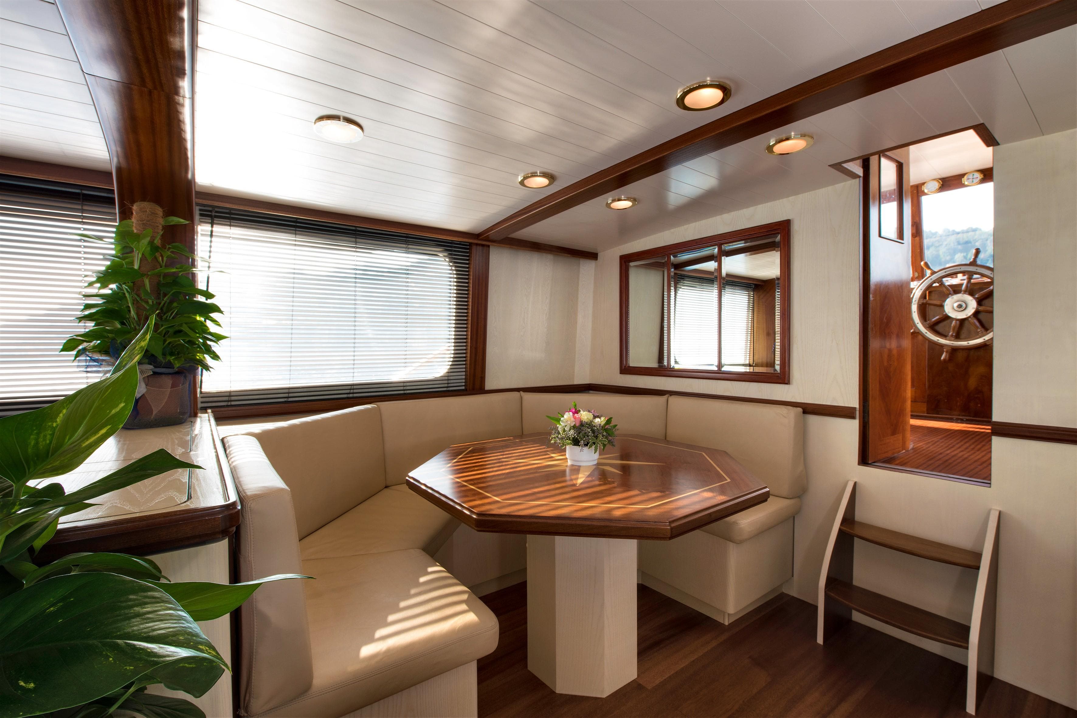 Luxurious 1957 Silver Yachts 85 interior with elegant wood finishes and cozy seating area.