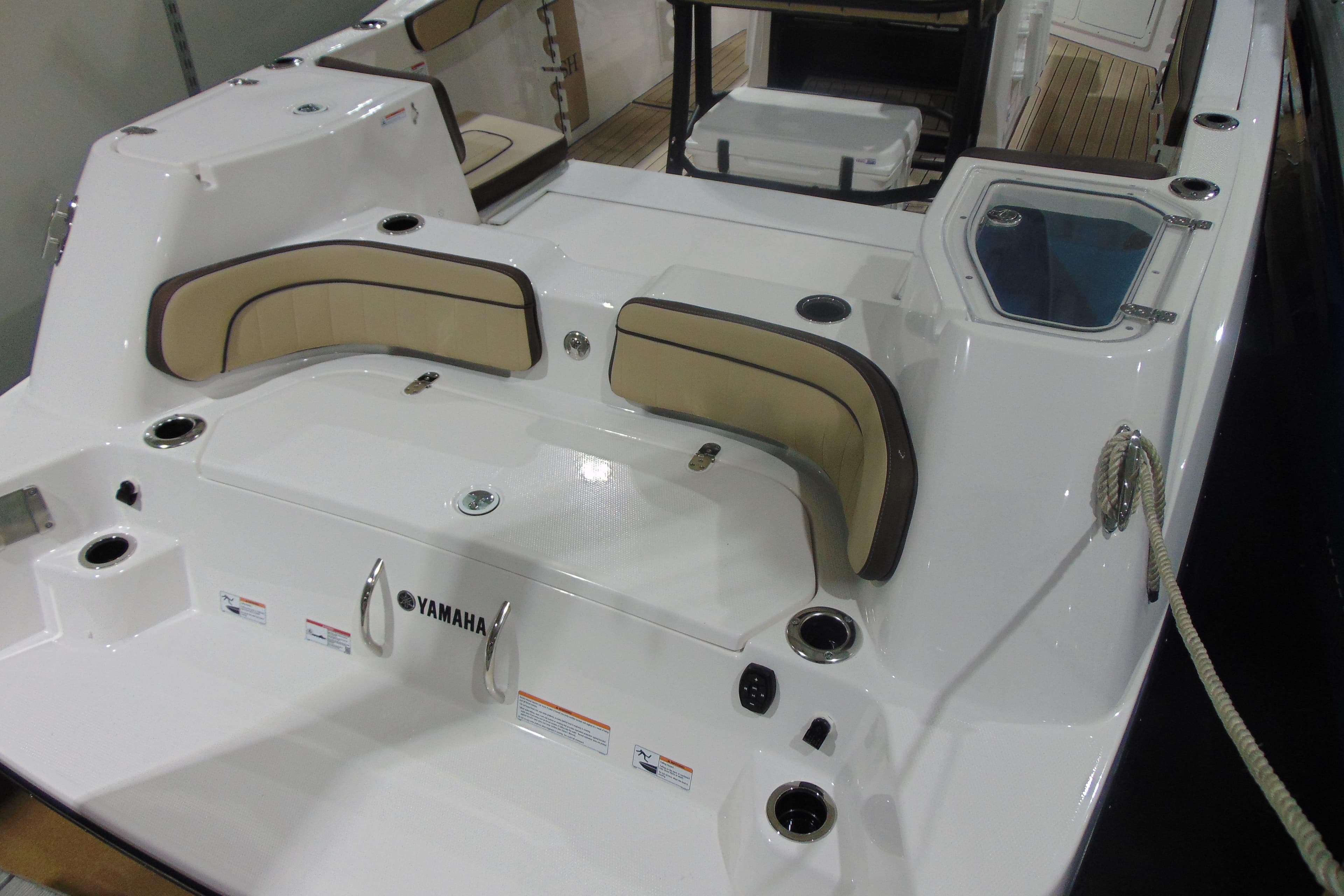 2026 Yamaha Boats 255 FSH Sport H interior with seating and storage features.