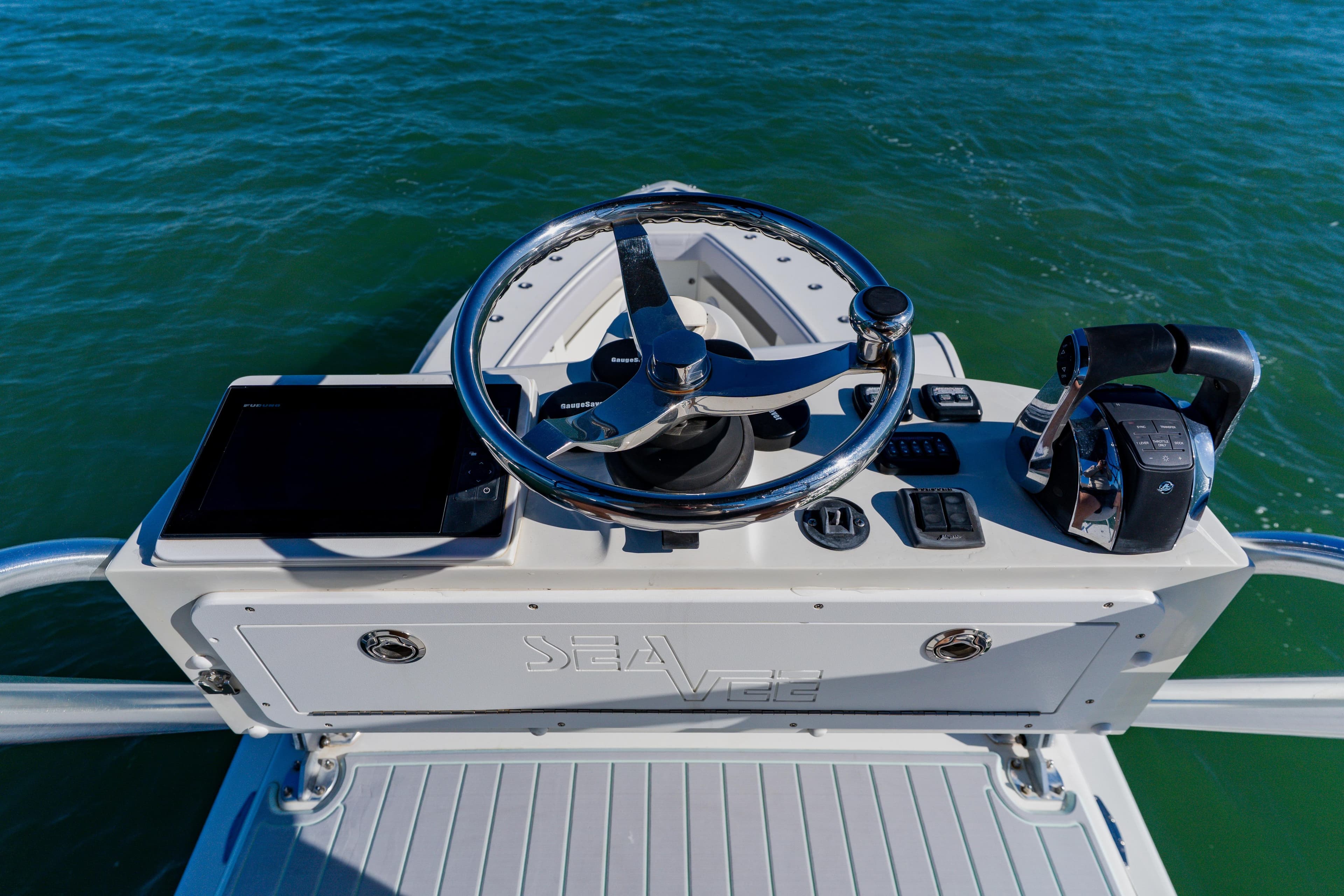 2012 SeaVee 390B boat helm with steering wheel and controls on open water.