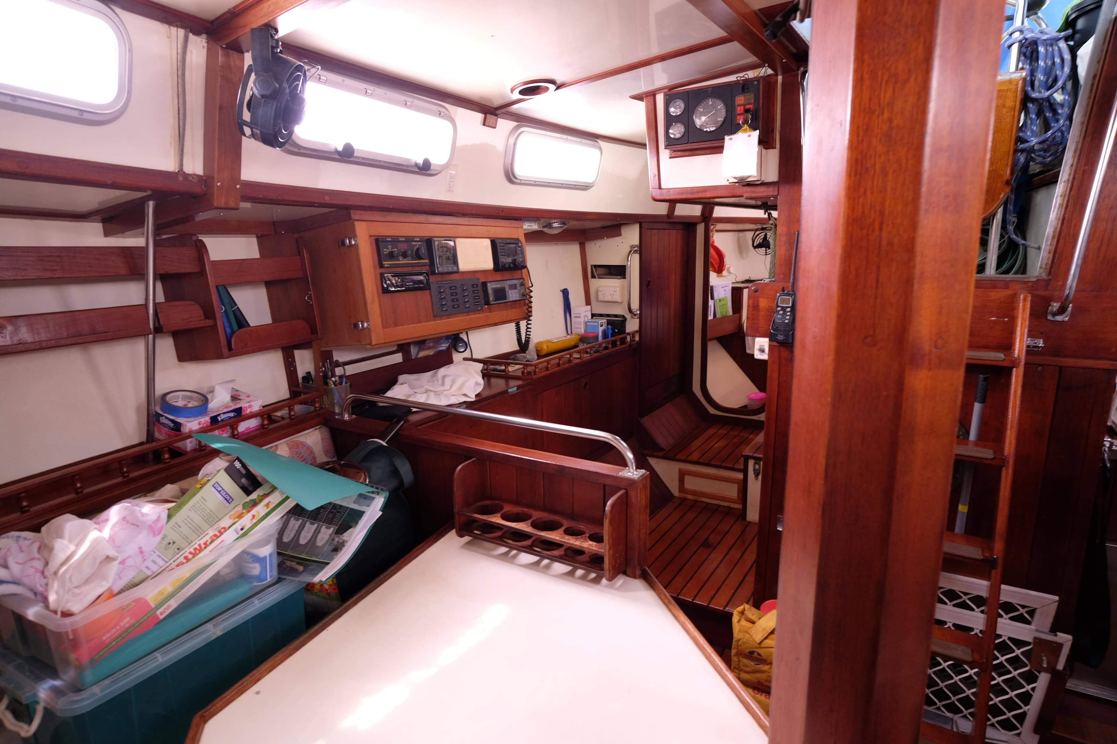 Interior of 1989 Bruce Roberts Offshore 38 sailboat with wooden cabinetry and navigation equipment.
