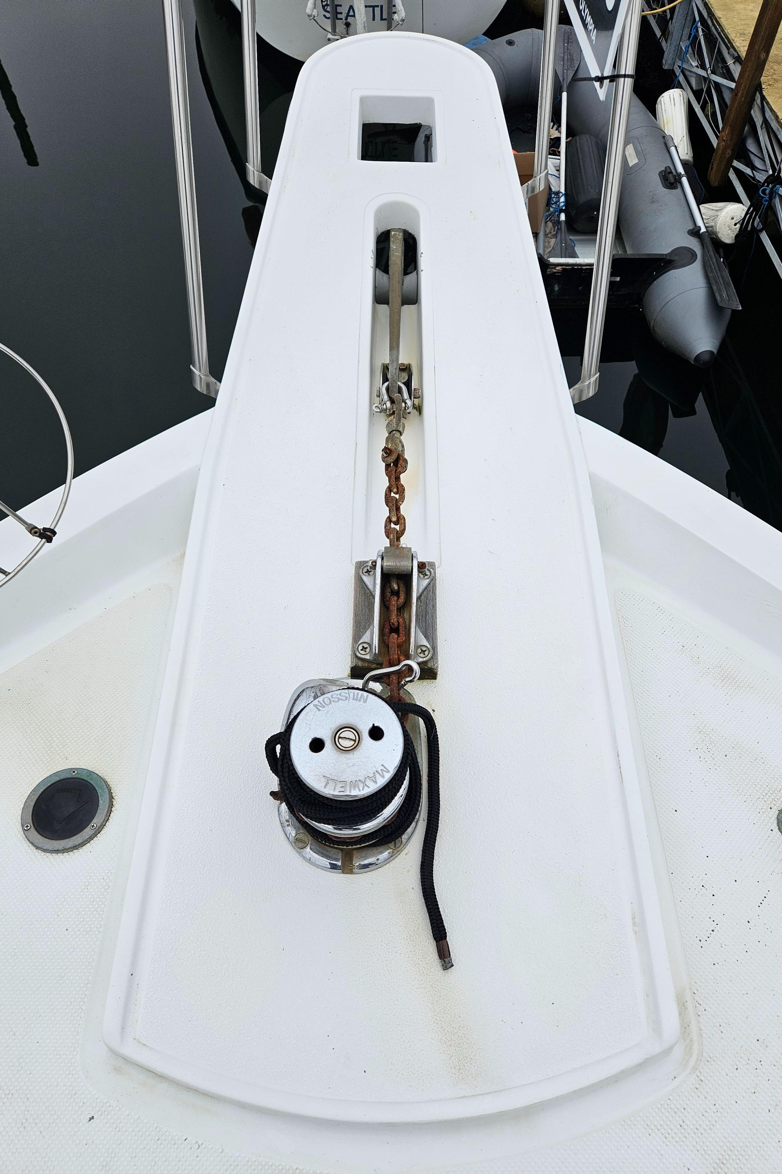 1991 Tollycraft Euro Sport Sedan boat deck with anchor chain and winch.