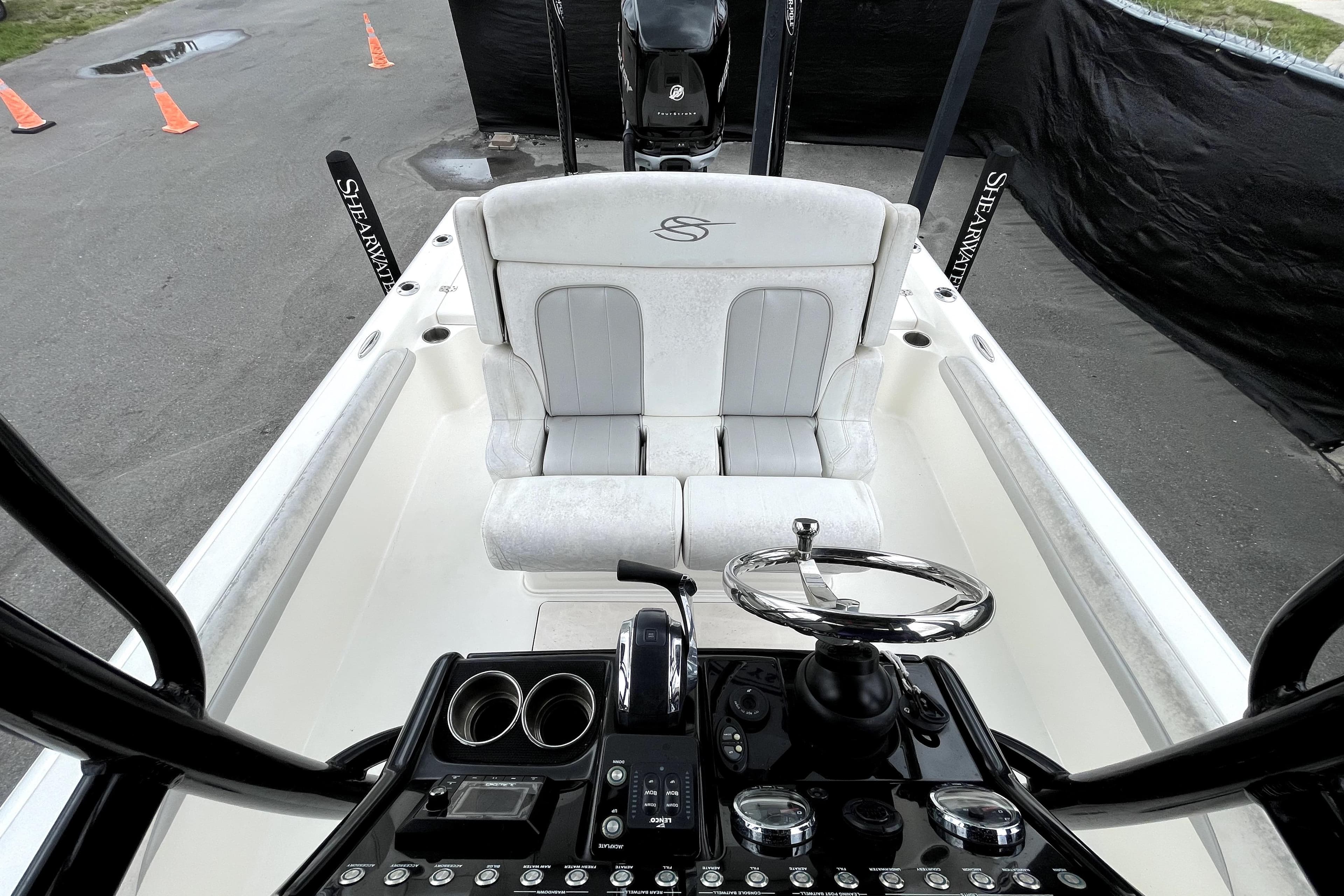 2019 ShearWater 25 LTZ boat interior with steering wheel and seating.