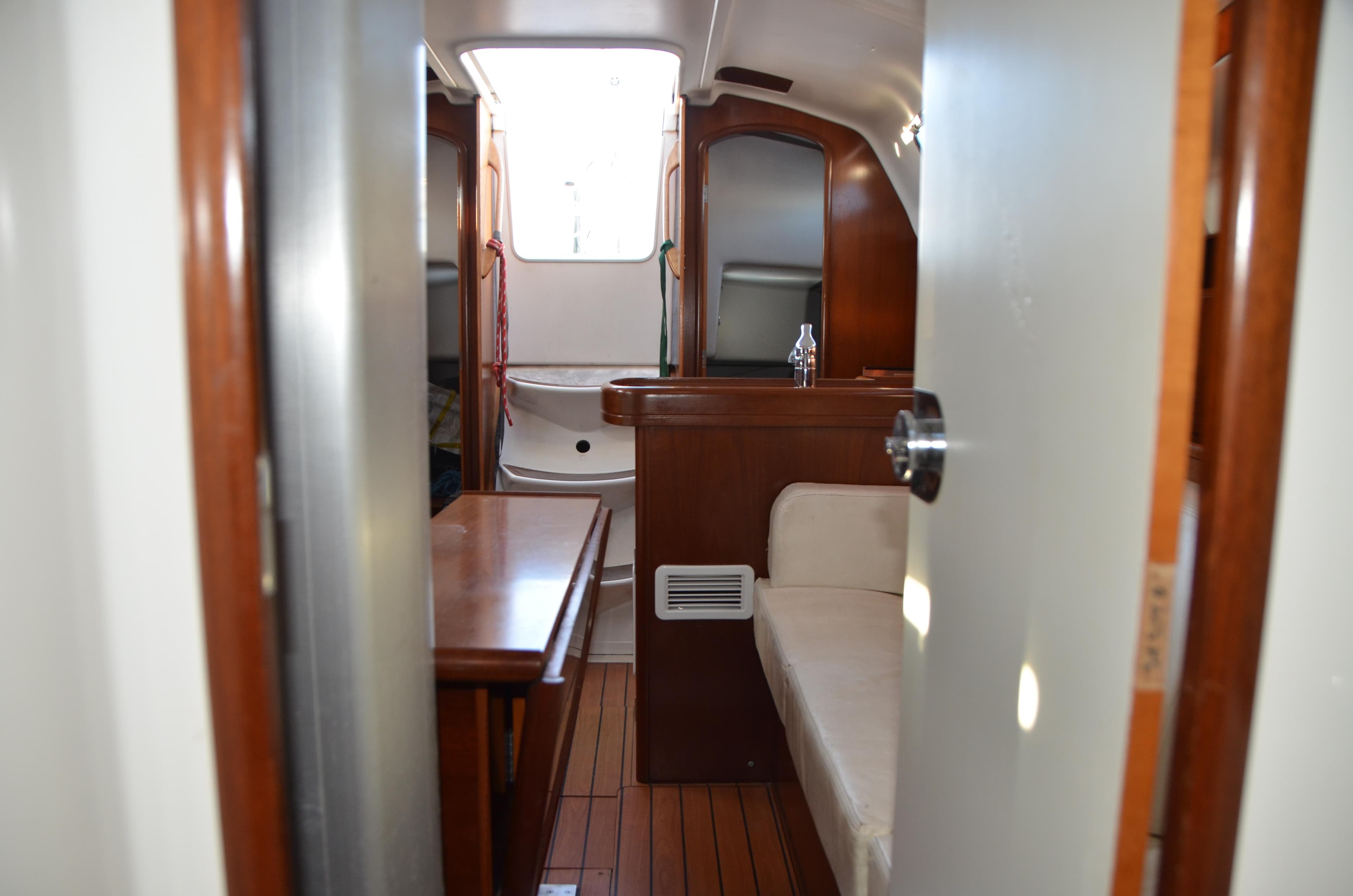 Interior of 2002 Beneteau First 36.7 sailboat, featuring wood finishes and seating area.