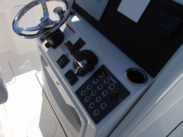 2025 Parker 2600 CC boat console with steering wheel and control panel.