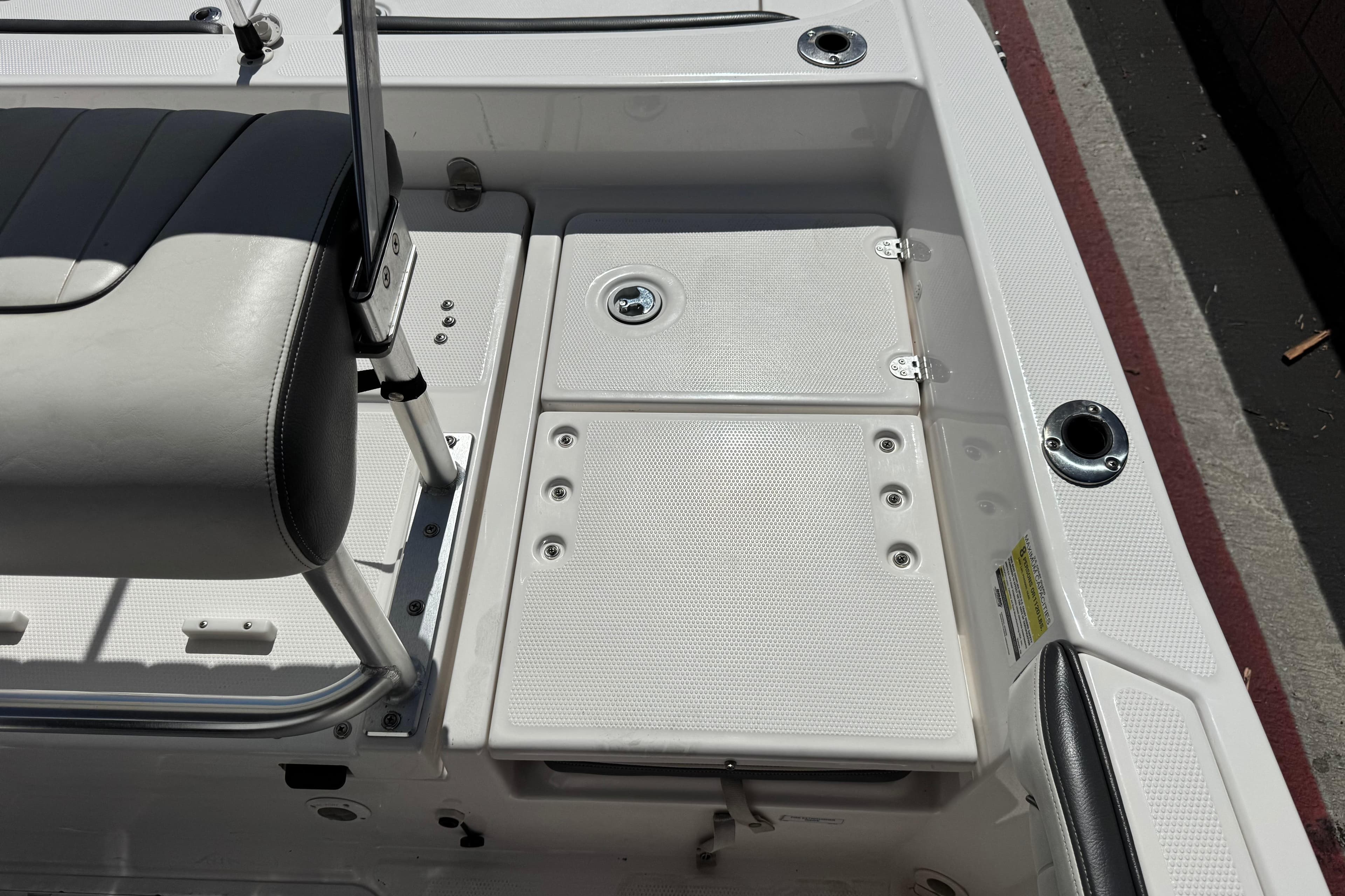 2016 Yamaha Boats 190 FSH Deluxe interior with seating and storage compartments.