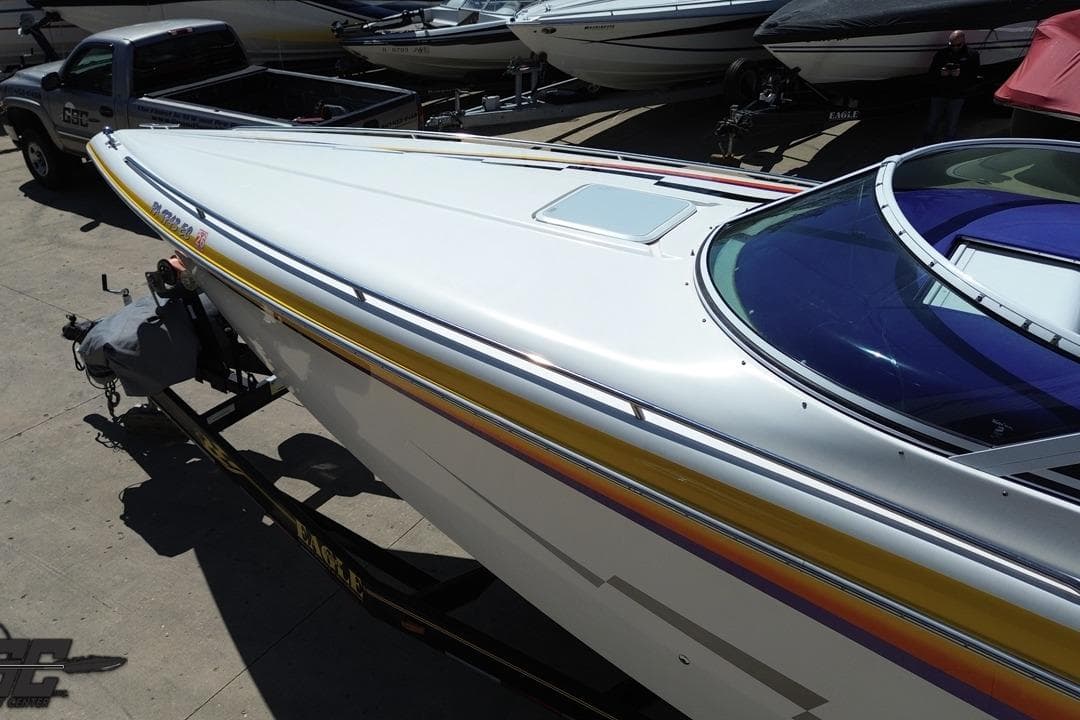 2001 Powerquest 340 Vyper boat on trailer, sleek design with vibrant accents.