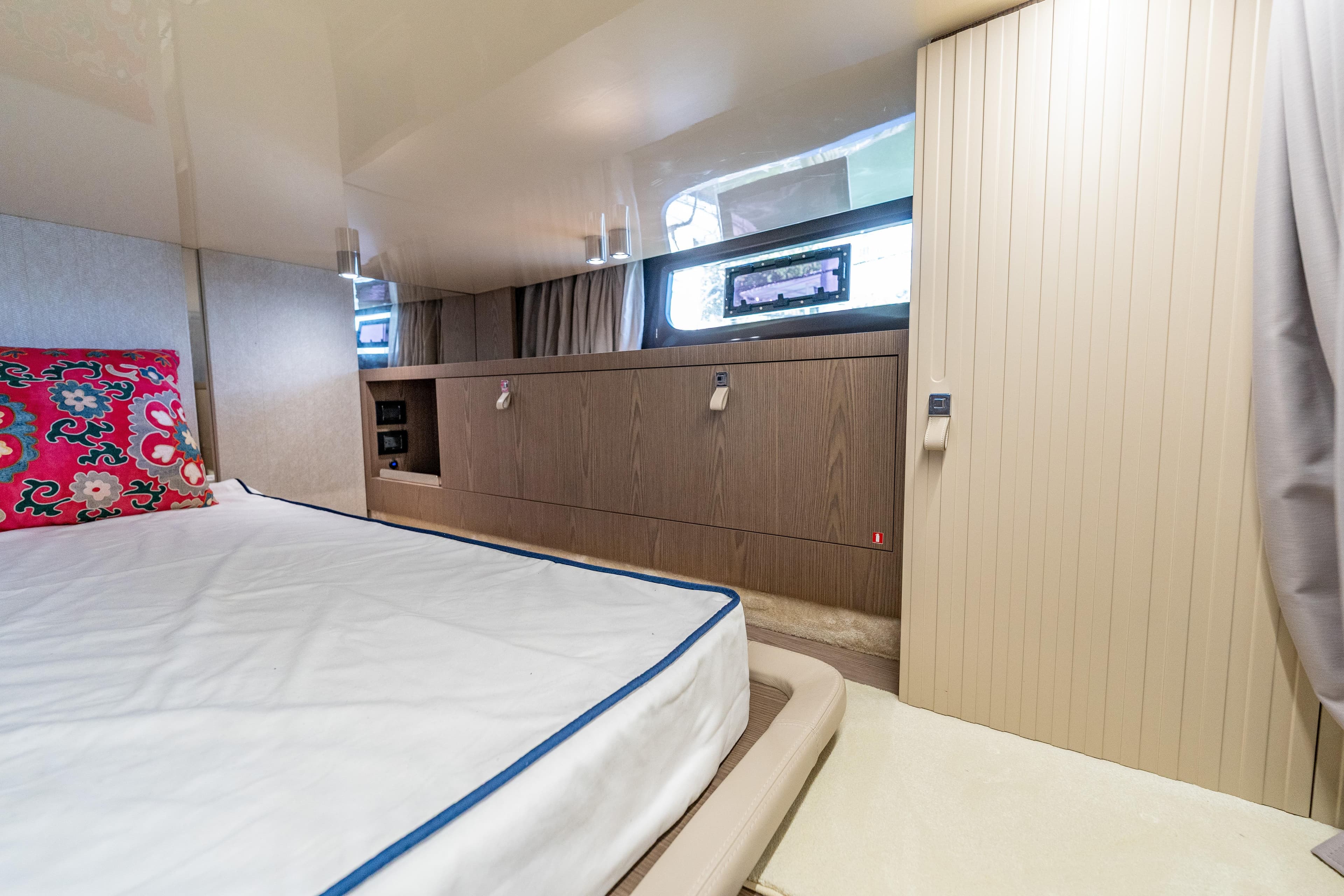 Luxurious cabin interior of 2024 Invictus 460 yacht with modern design and vibrant decor.