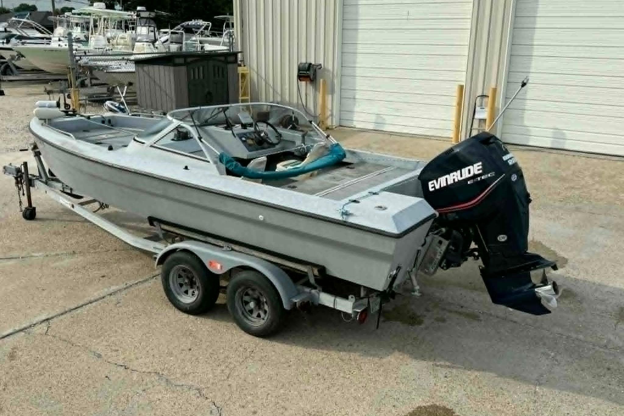 Custom Homemade 21 boat from 2000 with Evinrude motor on trailer.
