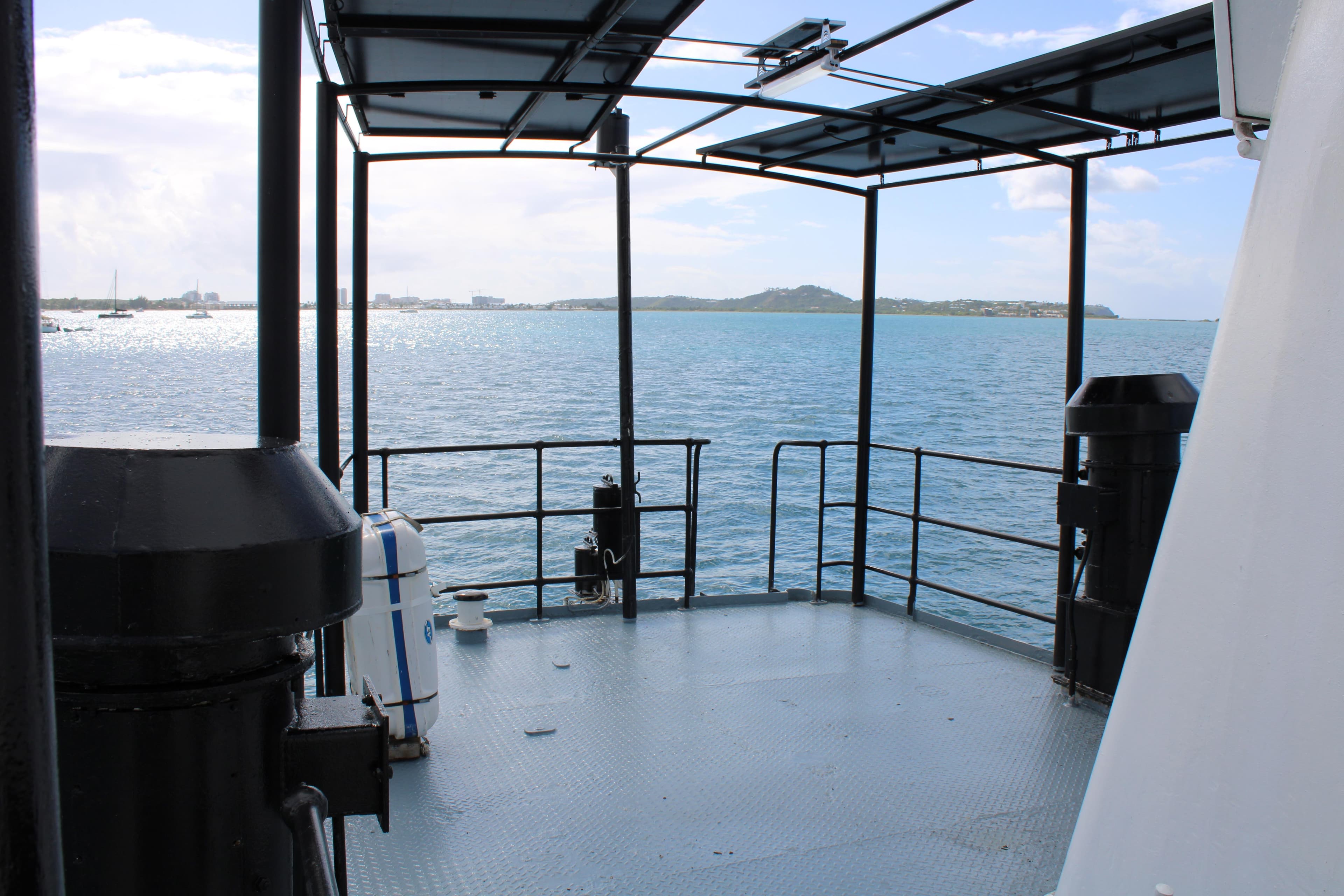View from 1970 Custom CD Holmes Clovelly Class Tender Fleet, overlooking serene ocean and distant shoreline.