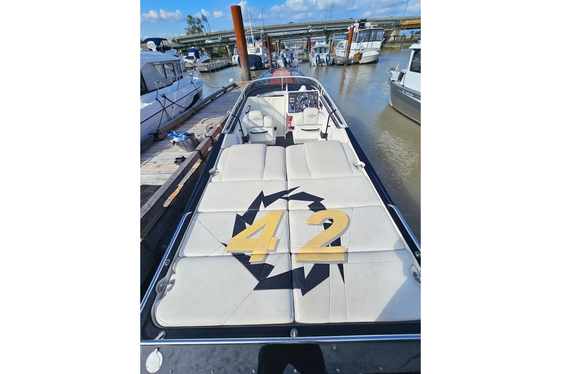 2004 Fountain 42 Lightning boat docked, featuring sleek design and spacious seating.