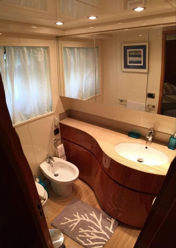 Luxurious bathroom in a 2000 Astondoa 82 GLX yacht with modern fixtures and elegant design.