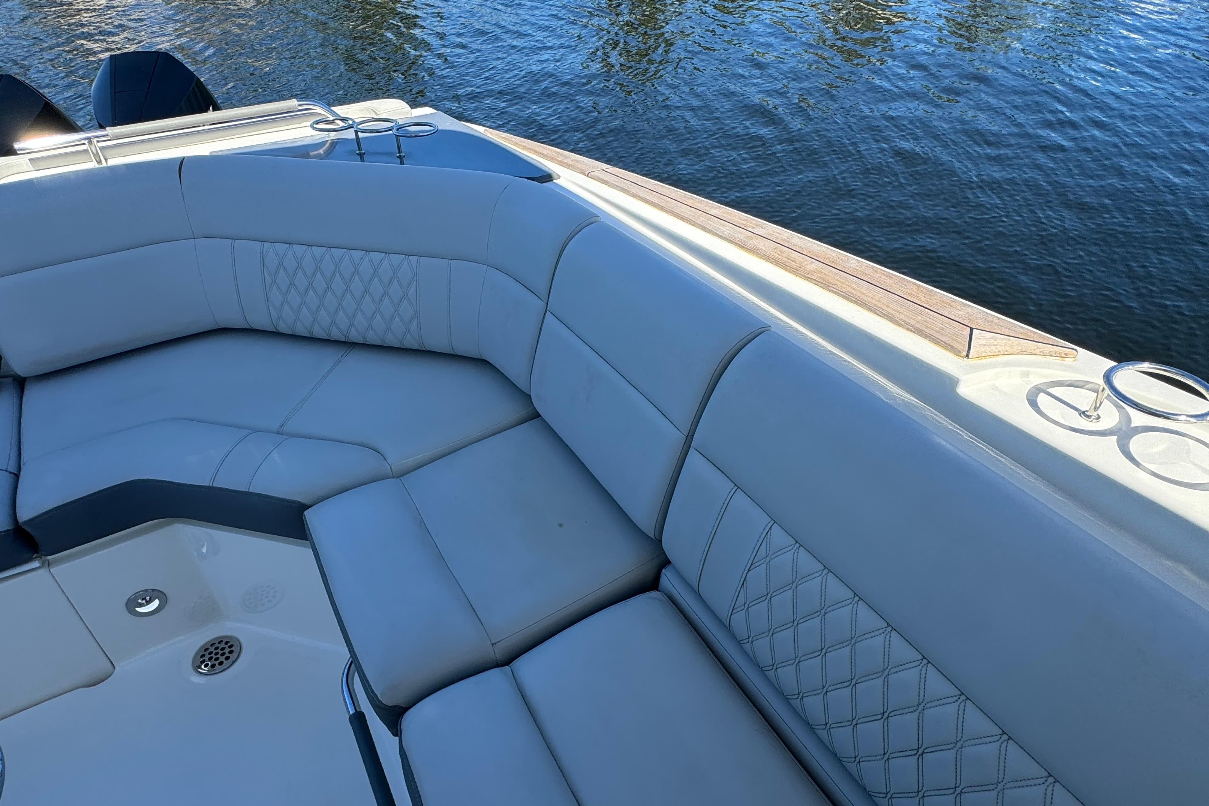 Luxurious seating on 2022 Sea Ray SLX 400 Outboard boat, overlooking calm water.