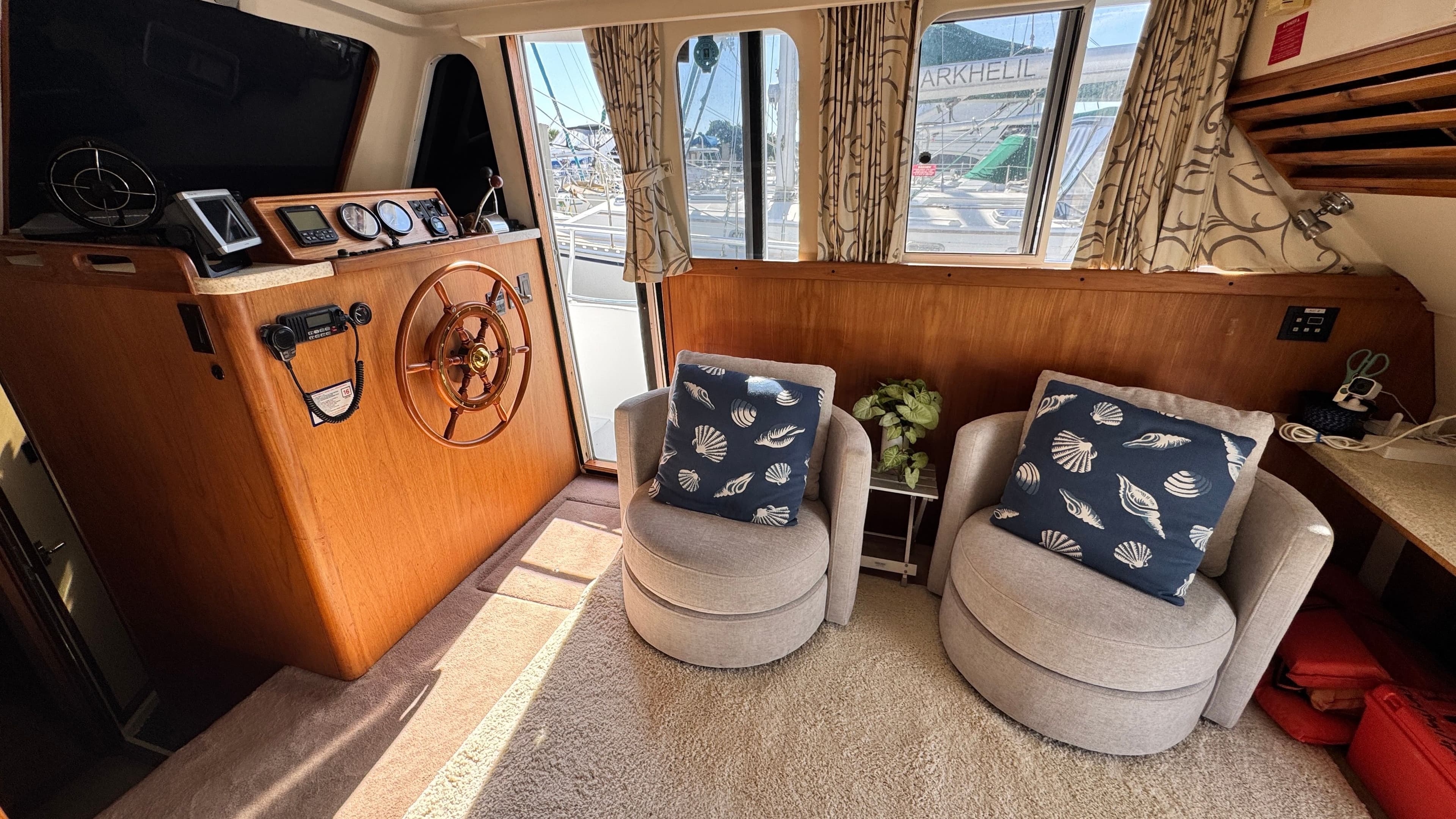 Interior of a 1999 Mainship 350 Trawler with helm and seating area.
