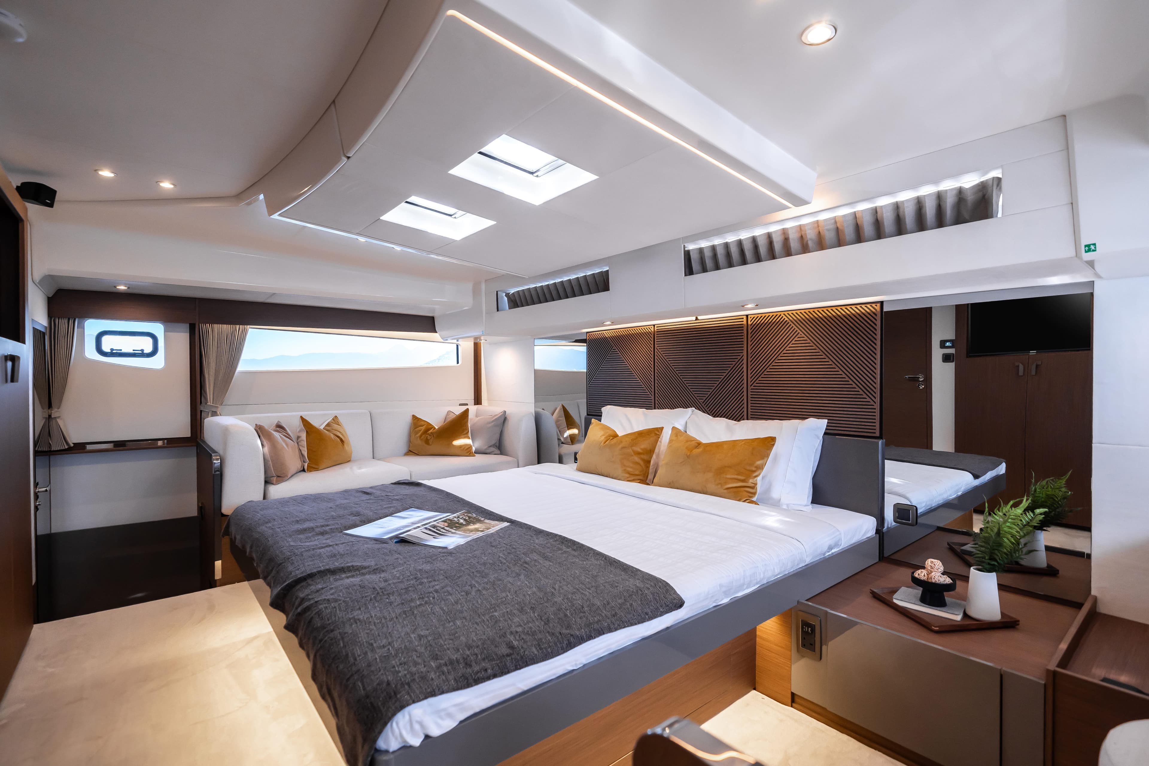Luxurious interior of 2025 Prestige M48 yacht with modern design and cozy bedding.