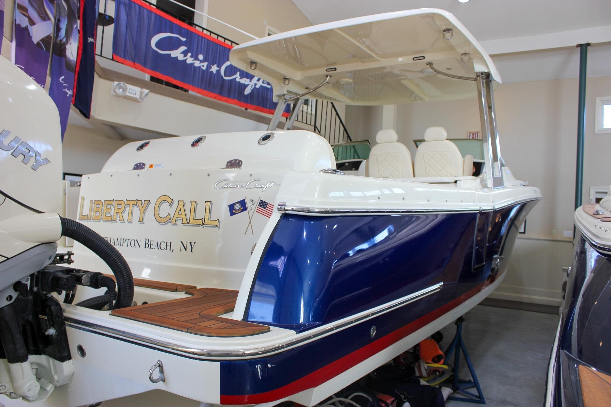 2018 Chris-Craft Calypso 30 boat in showroom, blue and white design, Hampton Beach, NY.