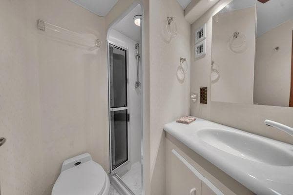 Bathroom interior of a 1993 Viking Convertible yacht with shower and sink.