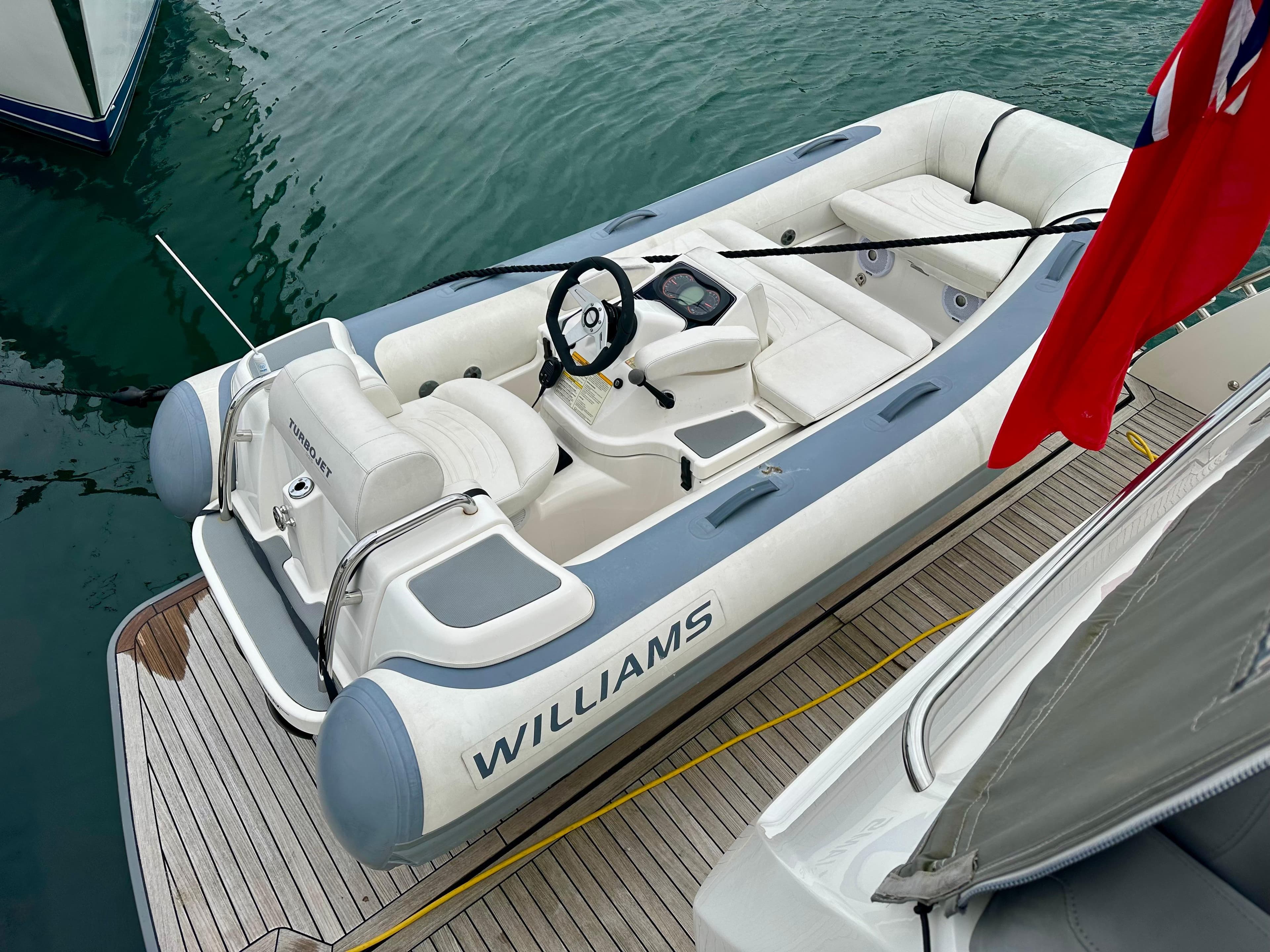 Inflatable Williams boat docked beside a 2014 Princess V52 yacht.