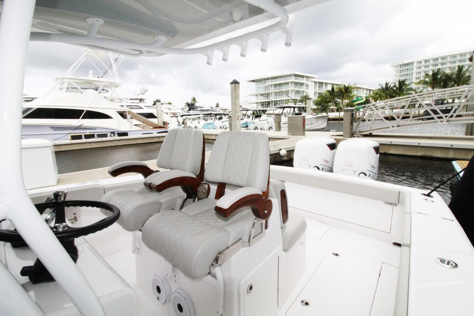 2024 Jupiter 34 HFS boat interior with dual seats and marina background.