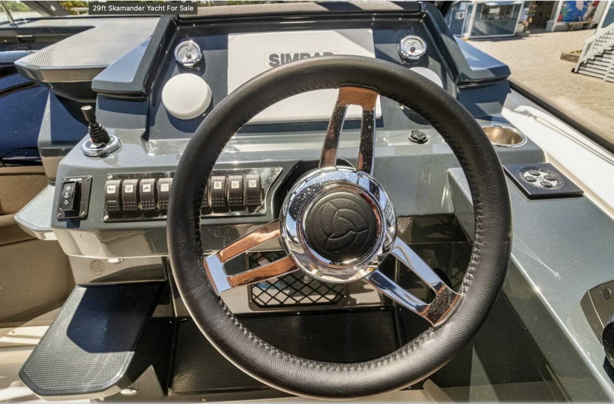 Steering wheel of 2024 Skamander 850 Voyager yacht with control panel.