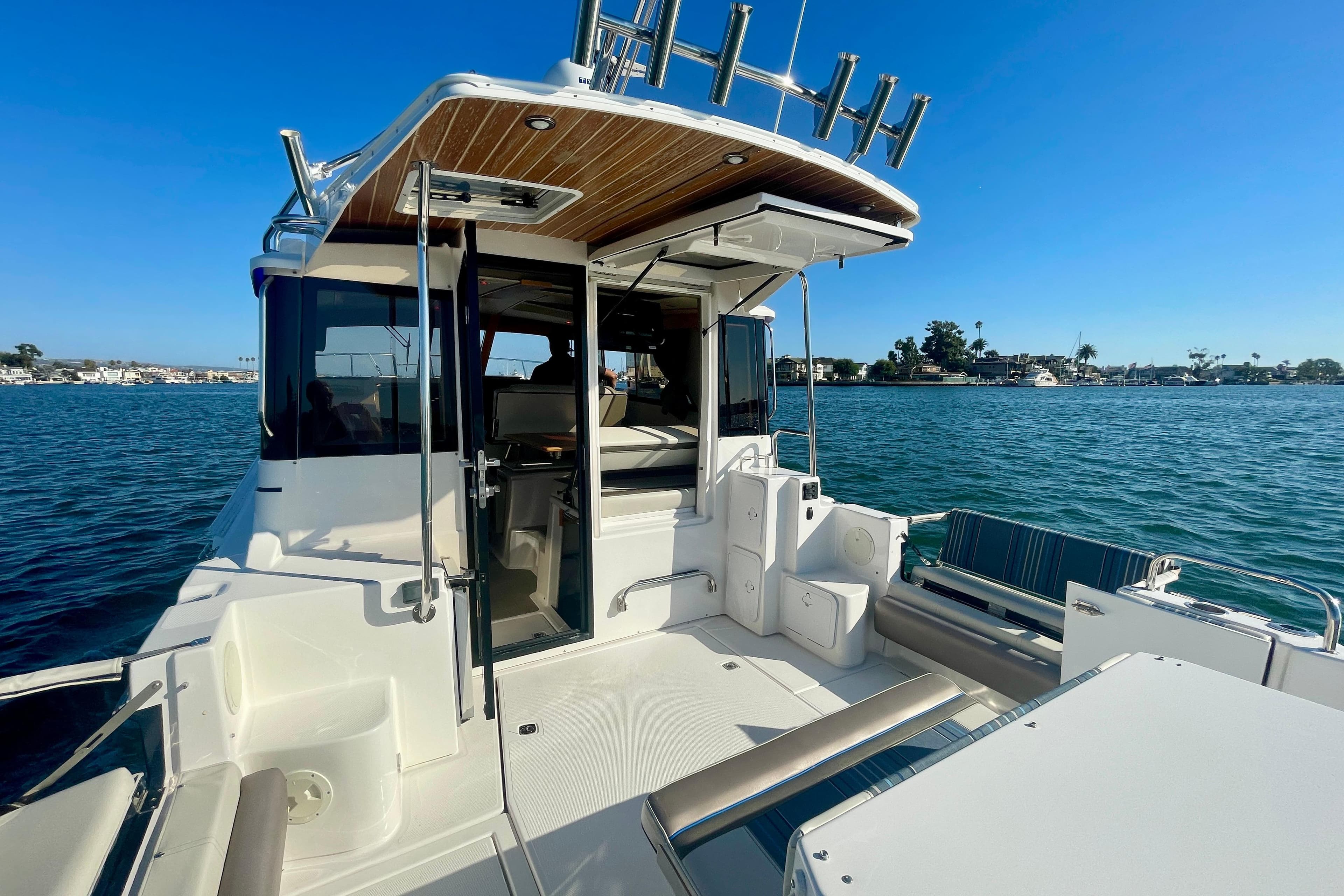 2019 Cutwater C-302 Coupe boat with open deck, docked on calm waters.