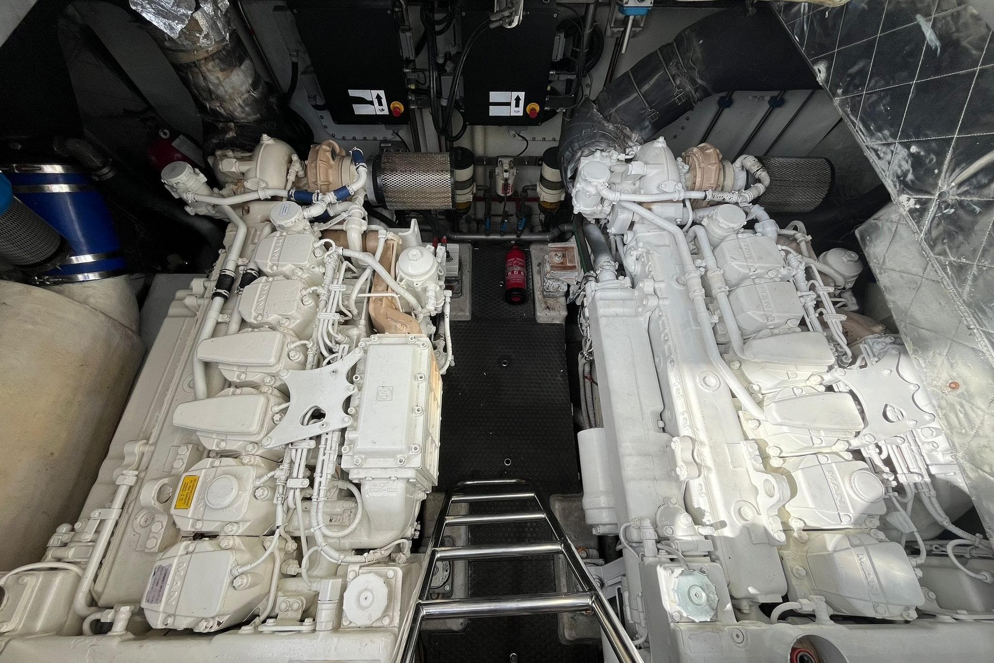 Engine room of 2007 Rizzardi Incredible 45 yacht, featuring dual white engines.