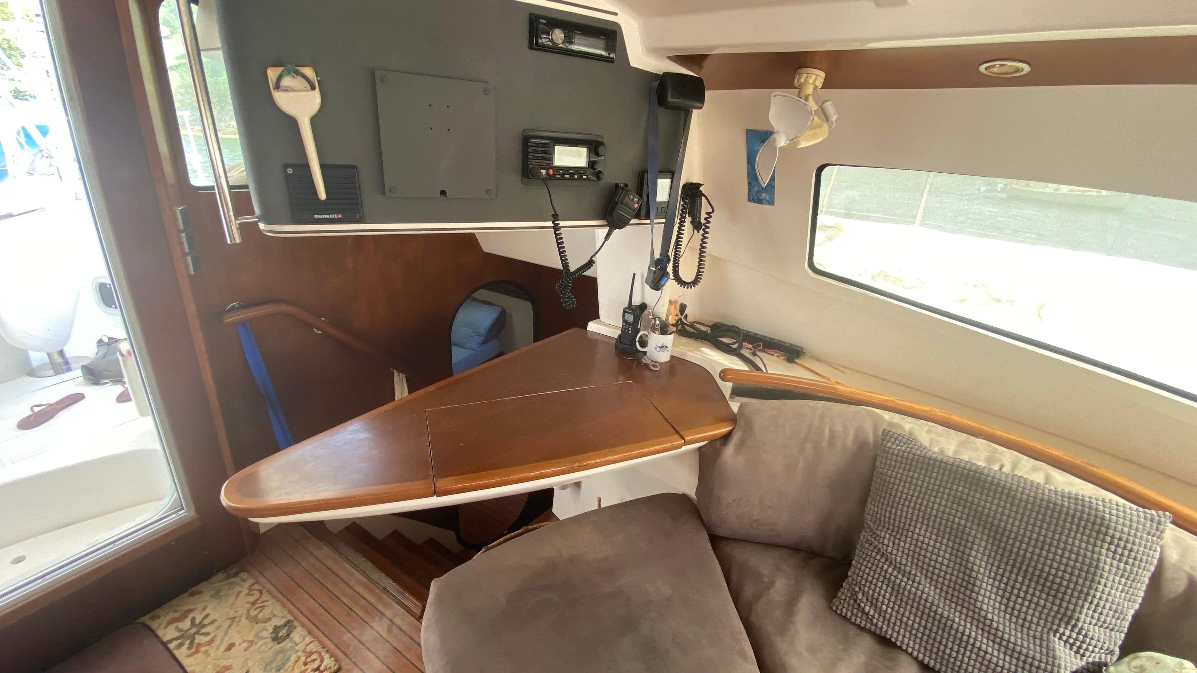 Interior of 1998 Fountaine Pajot Bahia 46 catamaran with navigation equipment and cozy seating area.