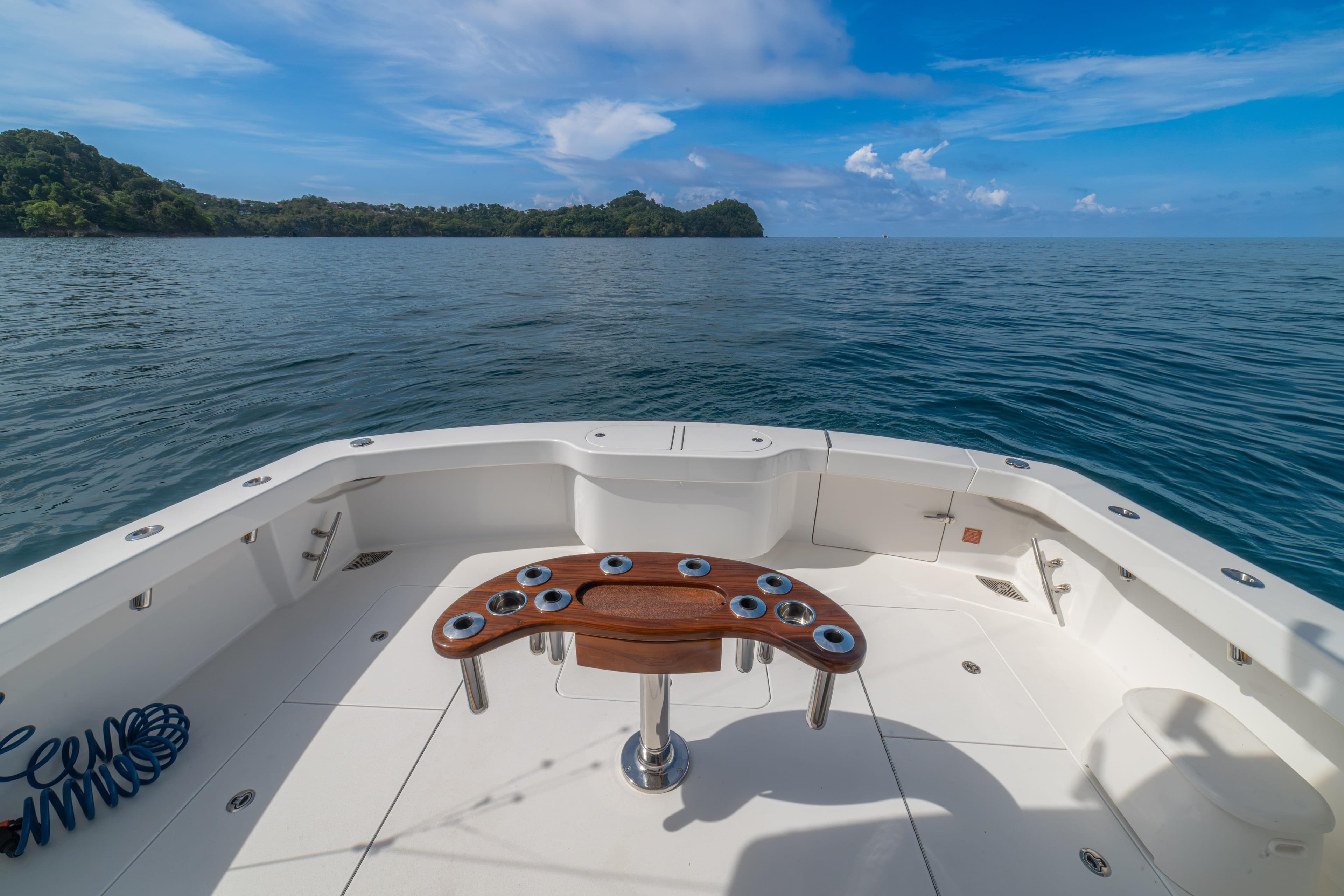 2024 Viking 48 Convertible yacht deck with ocean view and clear blue sky.