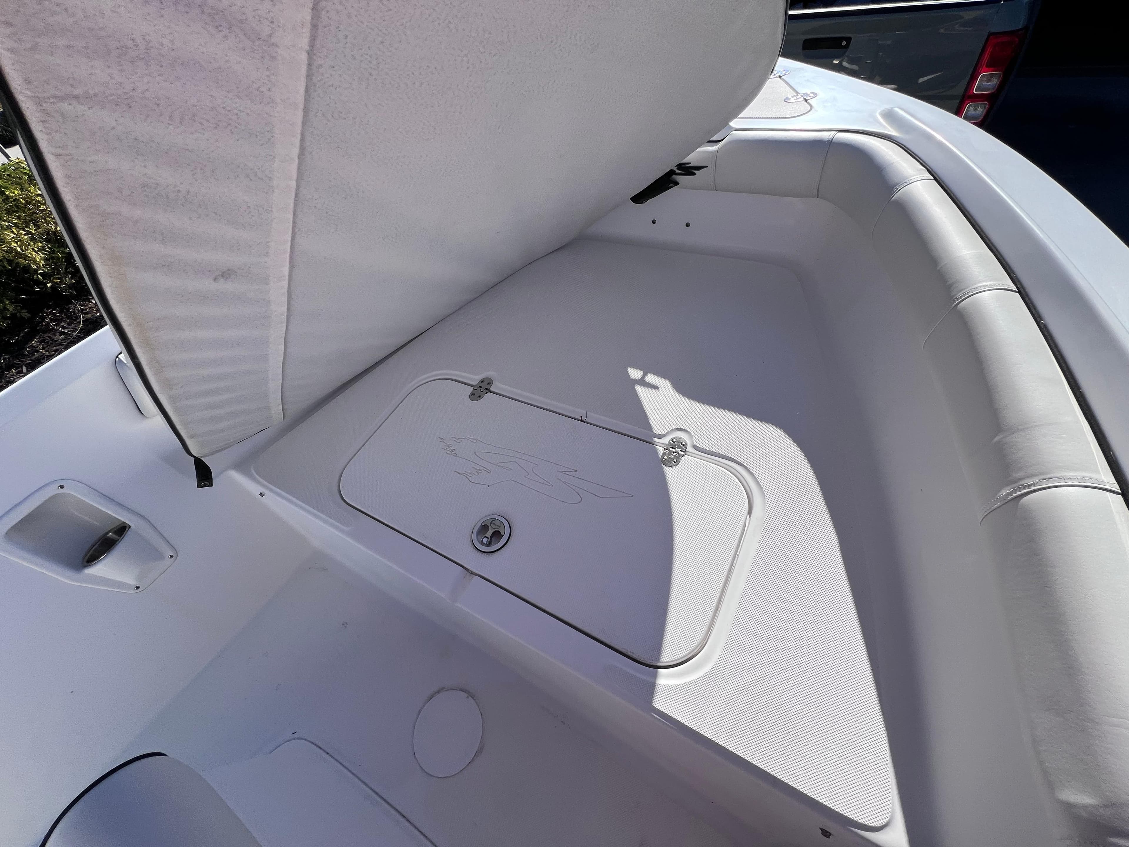 2021 Glasstream 180 CC boat interior storage compartment, open lid, white upholstery.