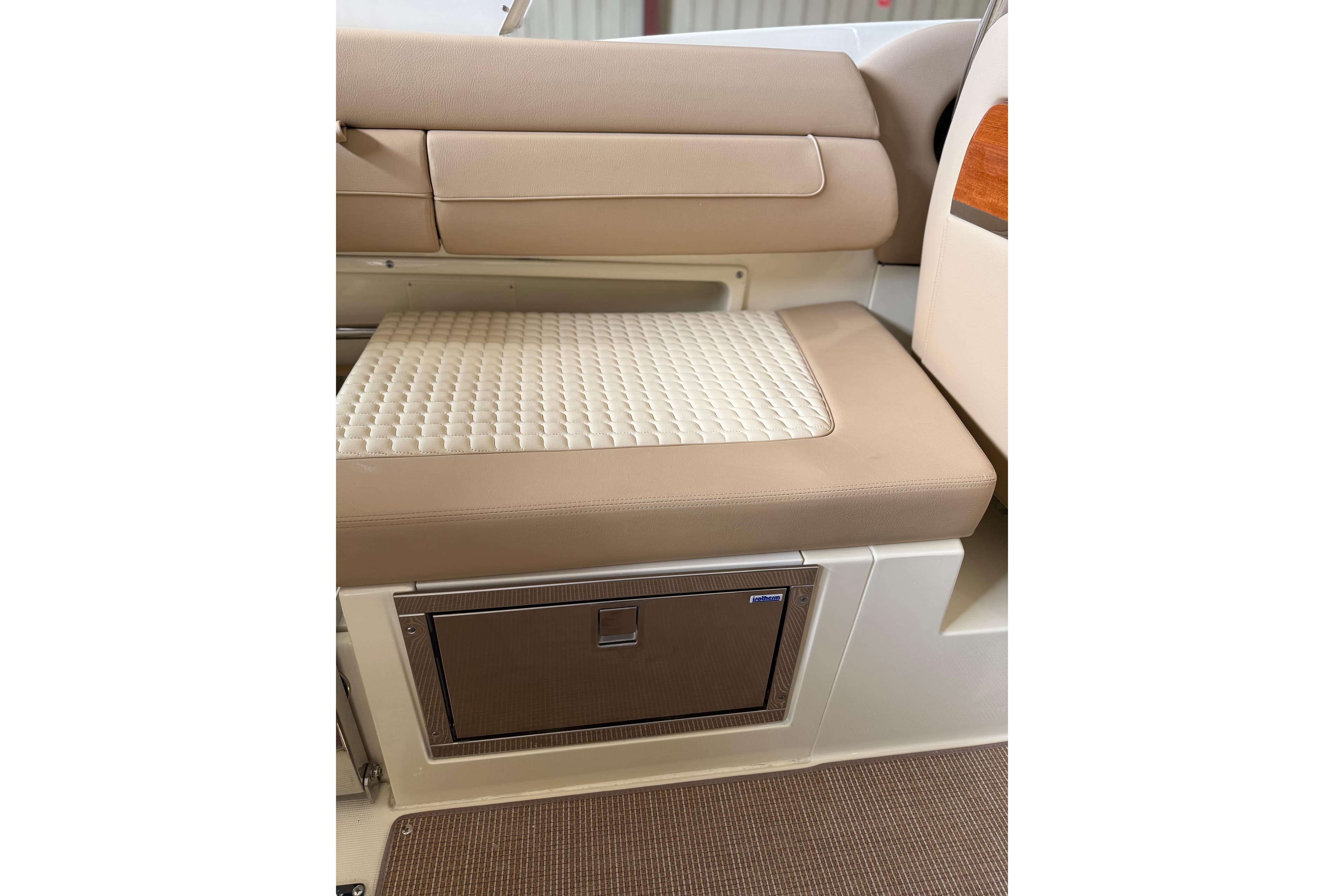 2026 Chris-Craft Launch 31 GT interior seating with quilted cushion and storage compartment.