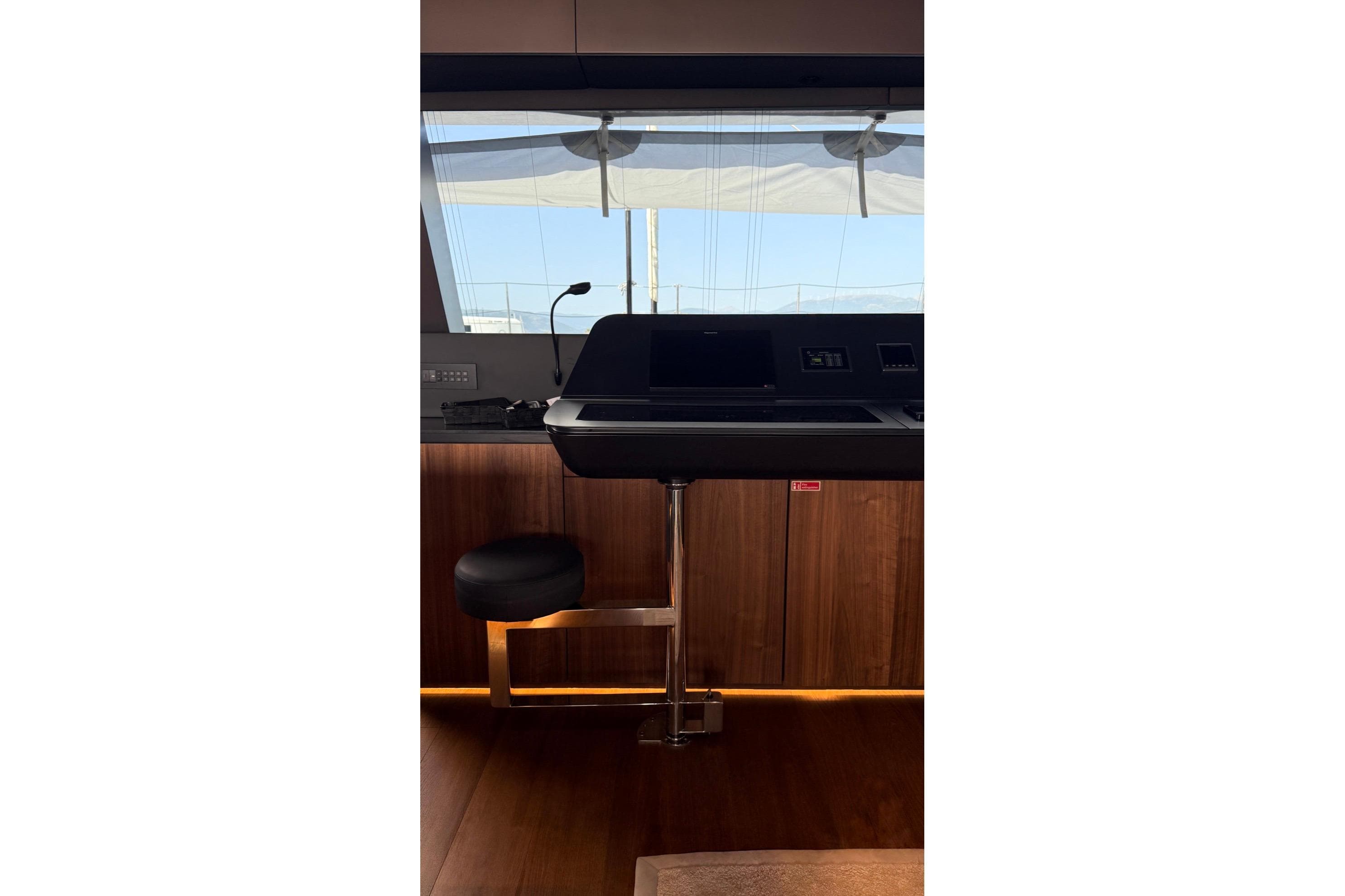 Luxurious interior of 2024 Sunreef 60 yacht with modern helm station and seating.