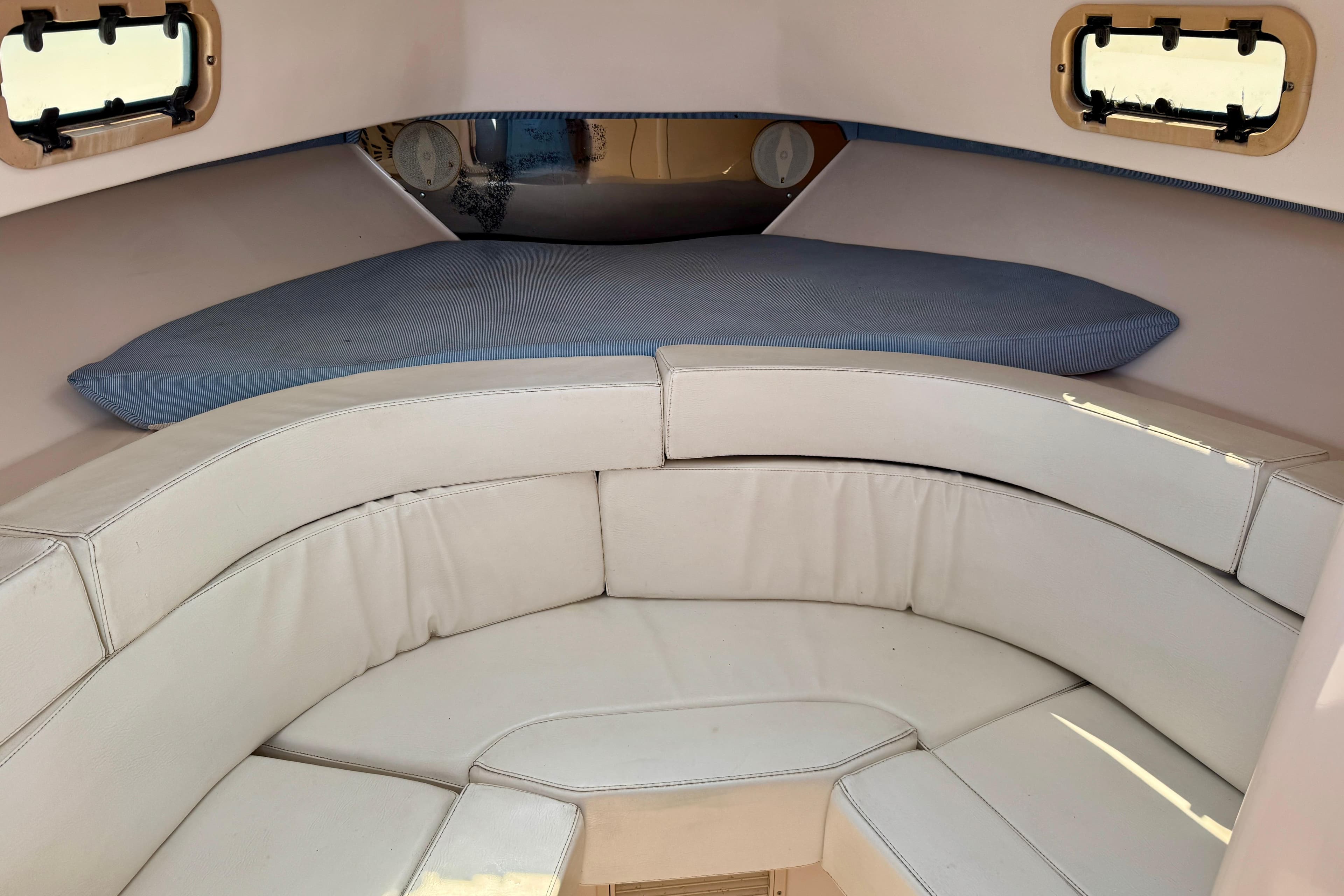 Interior cabin of a 2001 Intrepid 339 Walkaround boat with cushioned seating.