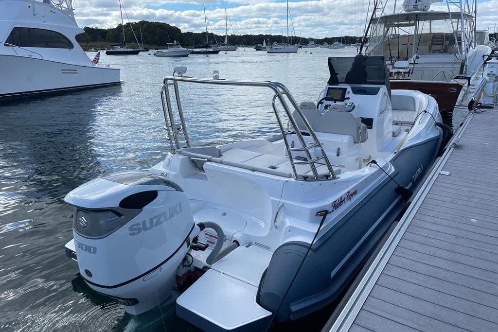 2022 Zar 79SL boat docked, featuring Suzuki outboard motor, in a marina setting.