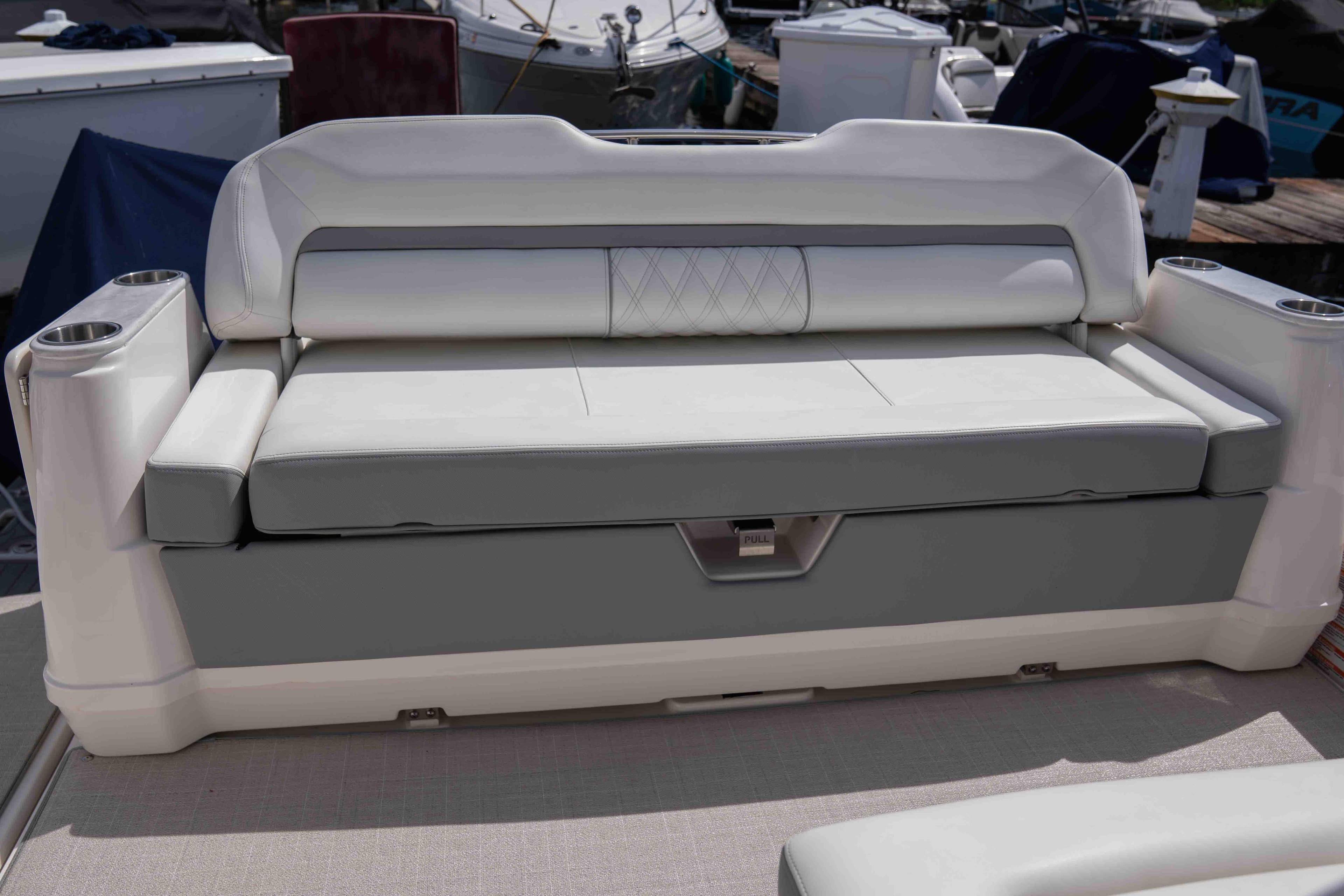 2024 Regal 36 Grande Coupe boat seating with cup holders, docked in marina.