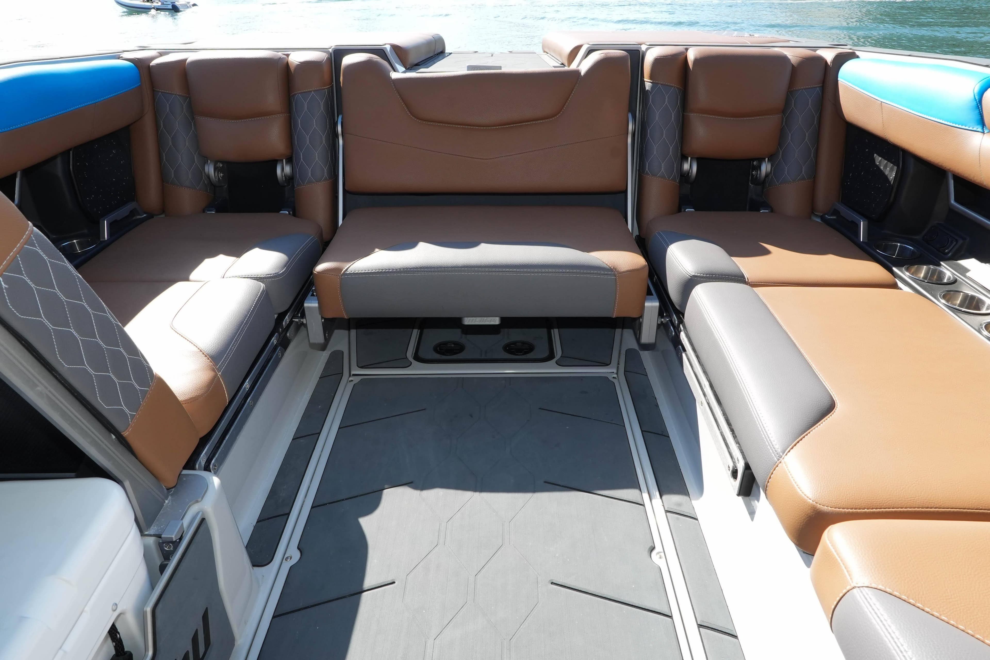 Interior seating of a 2020 Malibu M240 boat with brown and gray upholstery.