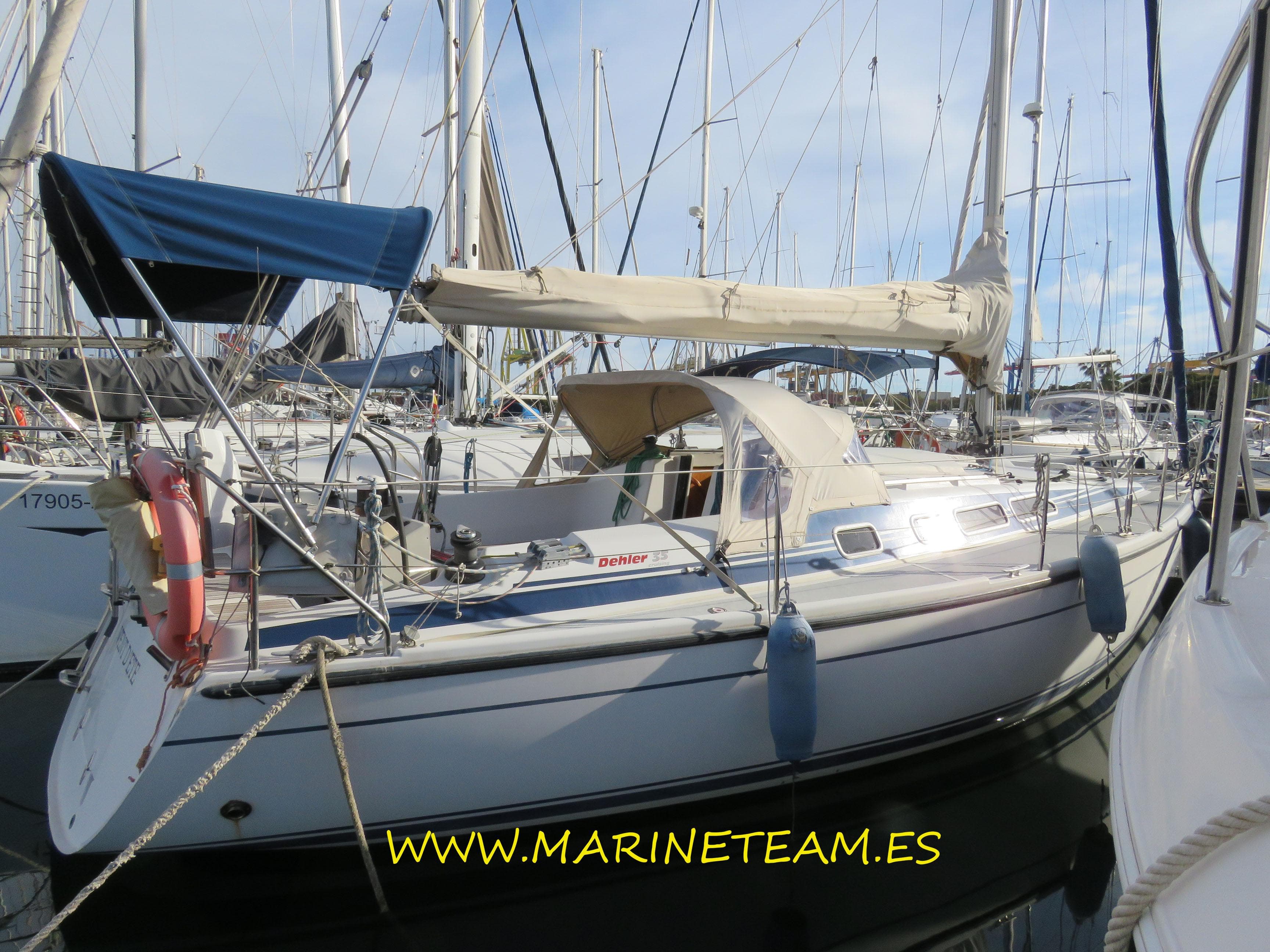 1997 Dehler 35 sailboat docked in marina, featuring blue and beige covers.