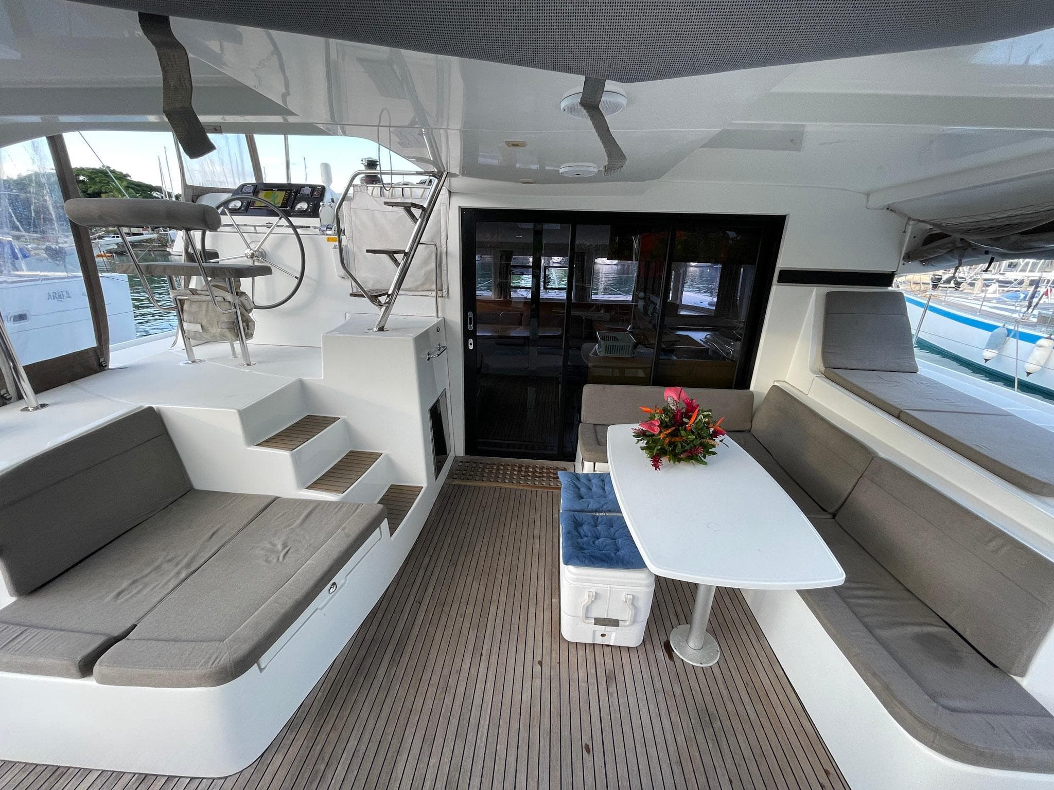 Spacious 2016 Lagoon 42 yacht cockpit with seating, table, and helm station.