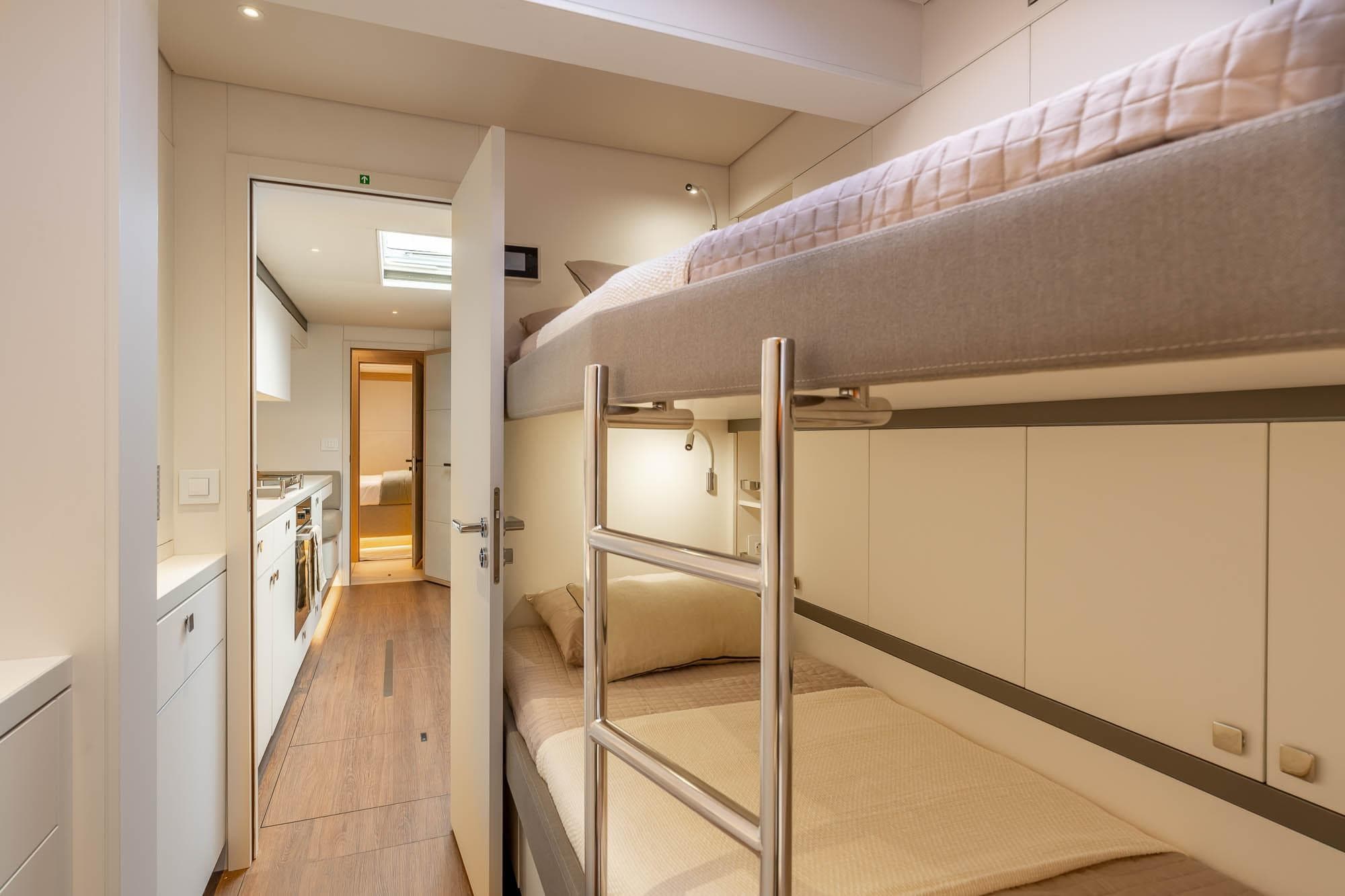Interior of 2026 Lagoon Eighty 2 yacht with bunk beds and modern design.